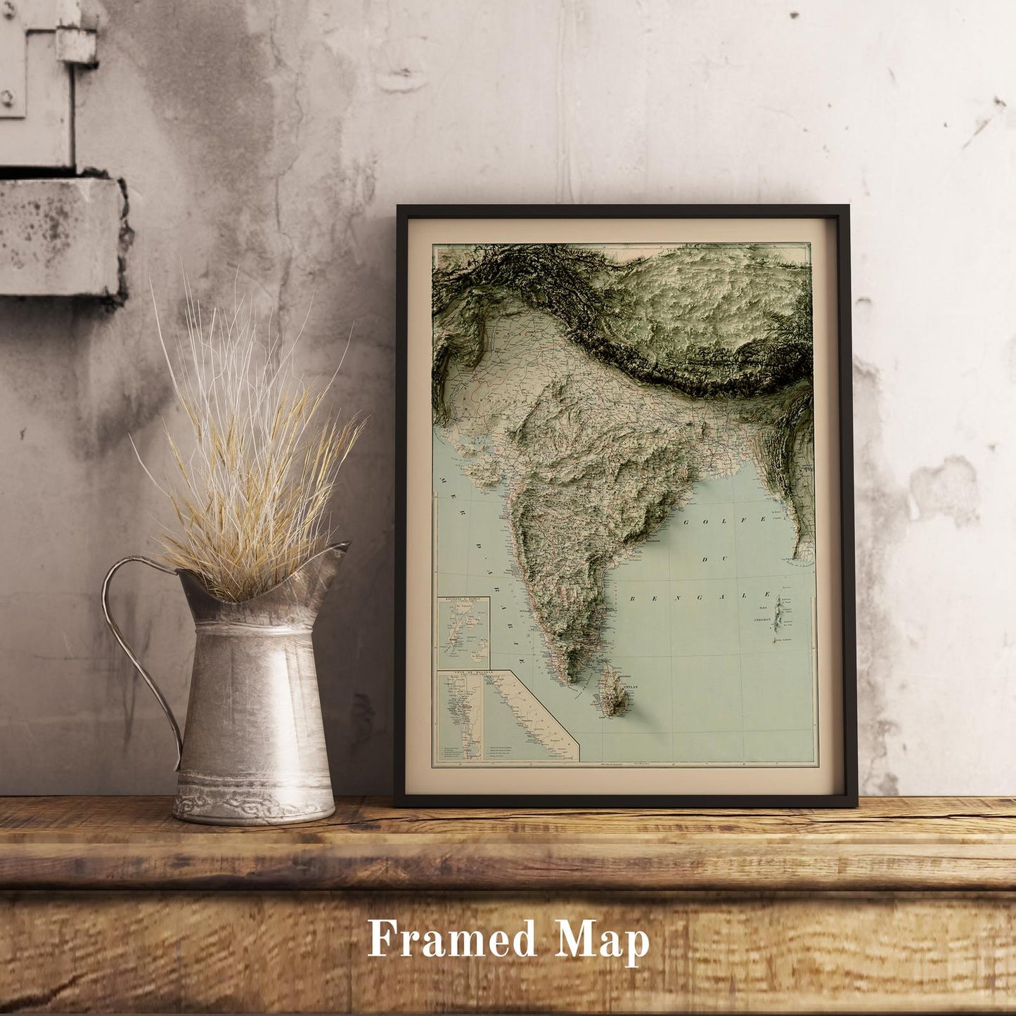 Vintage India shaded relief map in black frame. Realistic terrain art print for home decor, displayed on rustic wooden table