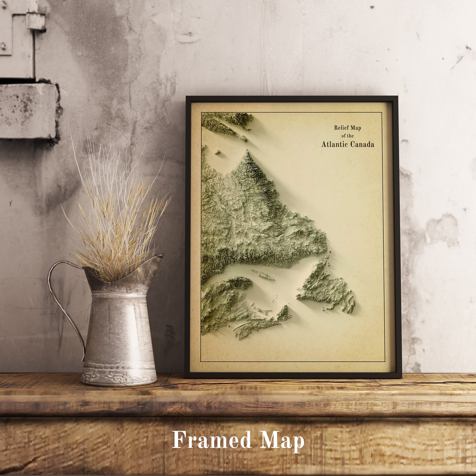 Vintage Atlantic Canada shaded relief map in black frame. Realistic terrain art print for home decor, displayed on rustic wooden table