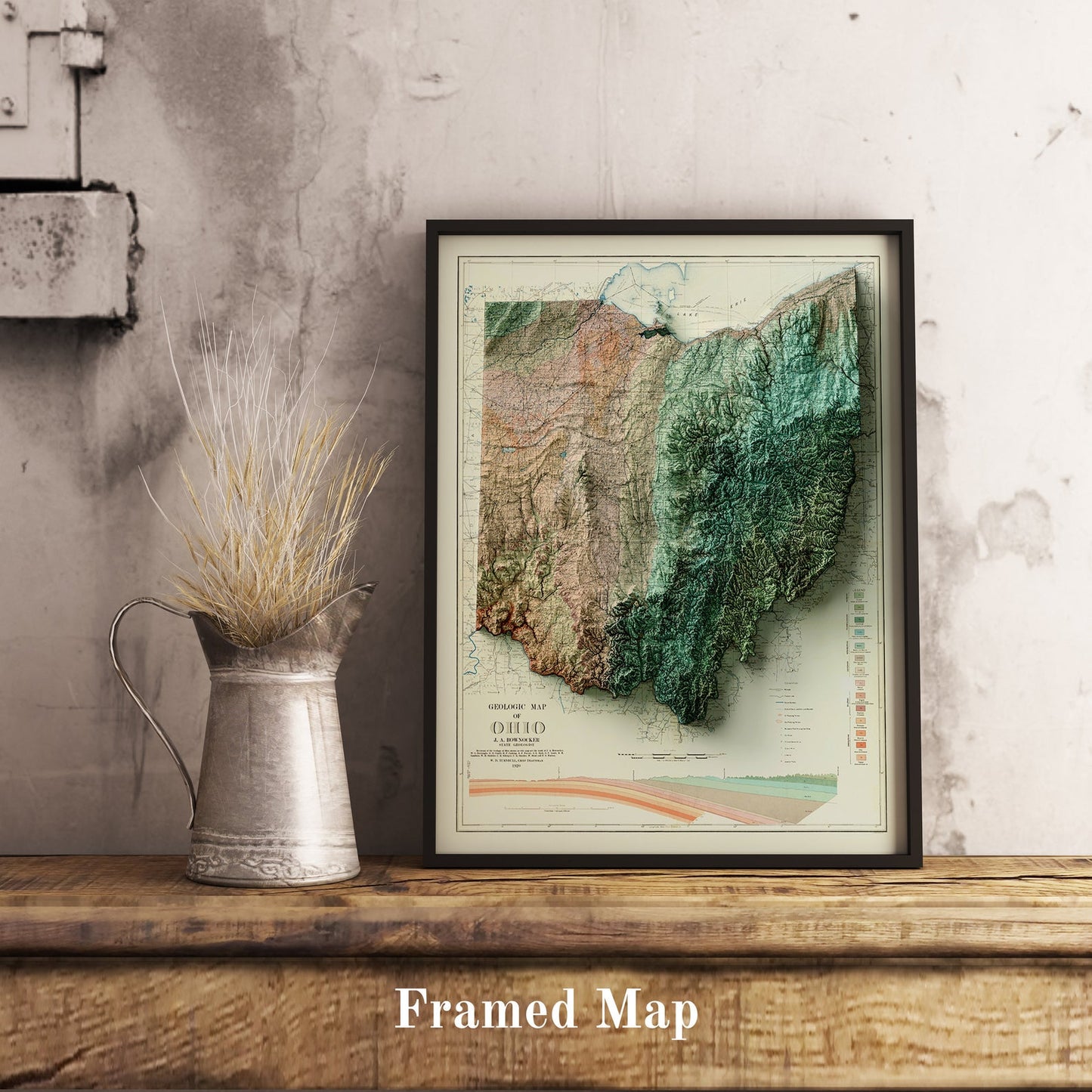 Vintage Ohio shaded relief map in black frame. Realistic terrain art print for home decor, displayed on rustic wooden table