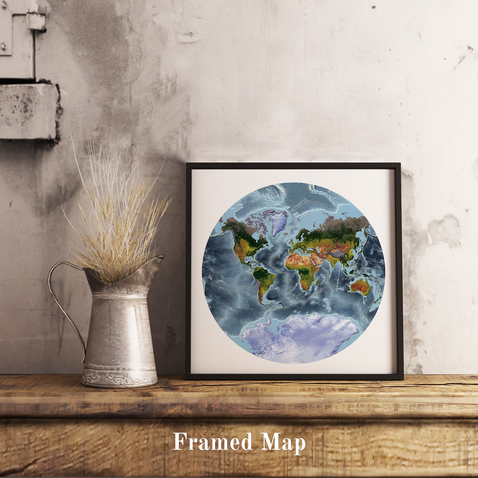 World shaded relief map in black frame, featuring the Van der Grinten Projection. Terrain art print for home decor, displayed on rustic wooden table