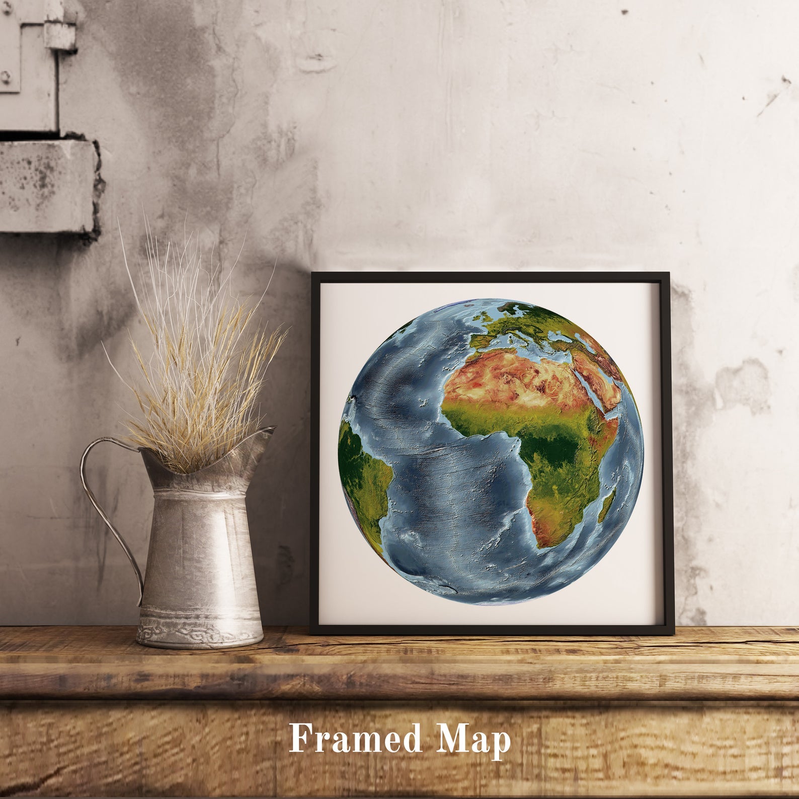 World shaded relief map in black frame, featuring the Vertical Perspective Projection. Terrain art print for home decor, displayed on rustic wooden table