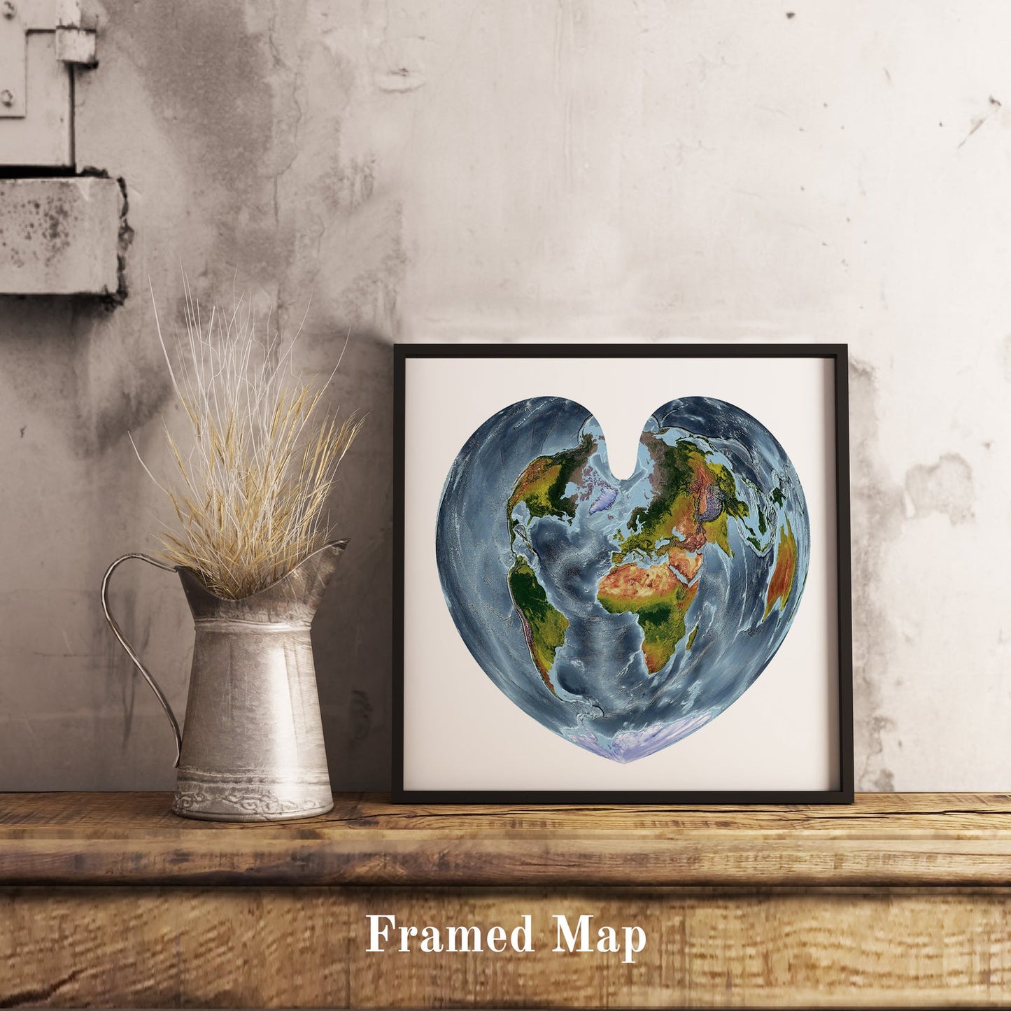 World shaded relief map in black frame, featuring the Bonne Projection. Terrain art print for home decor, displayed on rustic wooden table