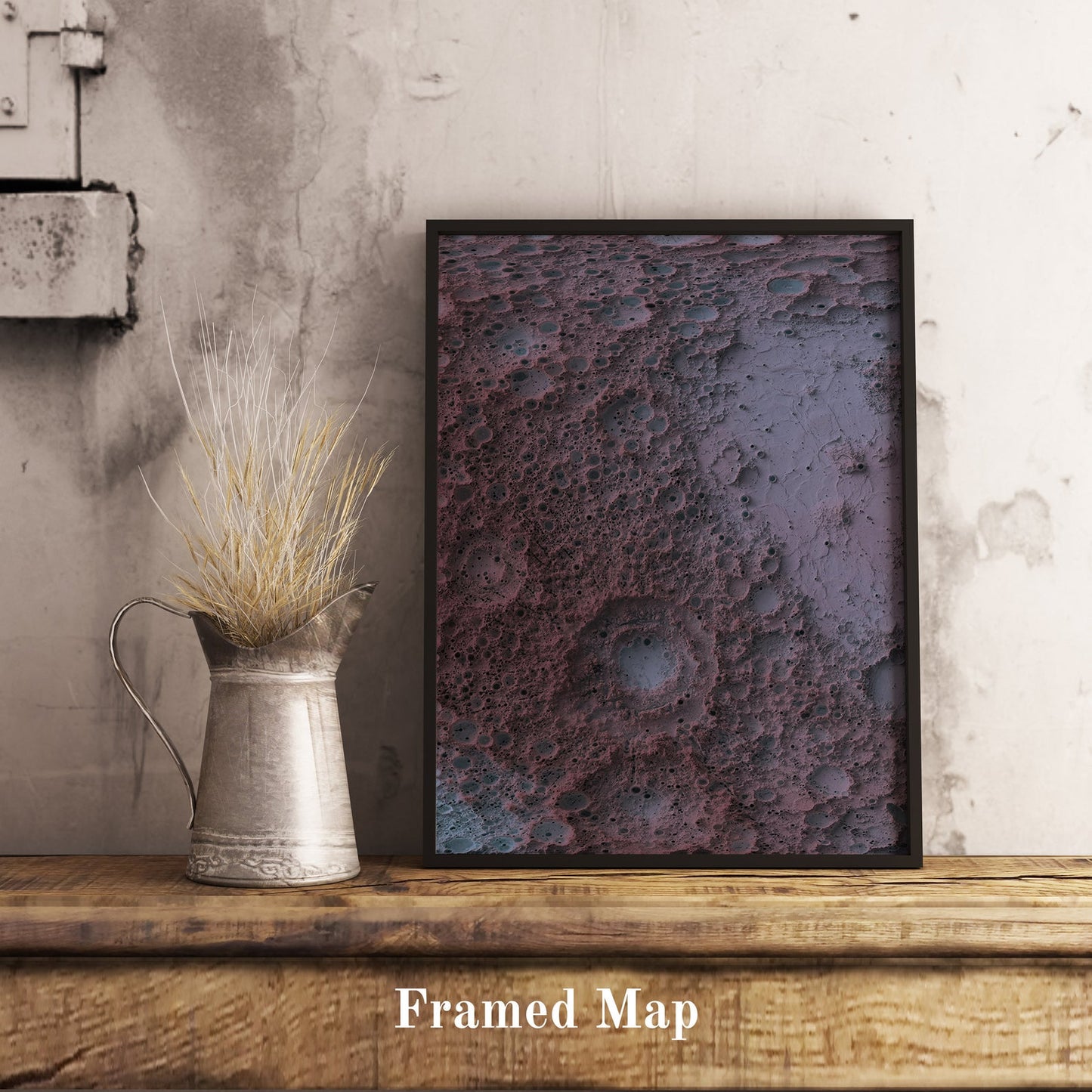Moon shaded relief map in black frame. Realistic terrain art print for home decor, displayed on rustic wooden table