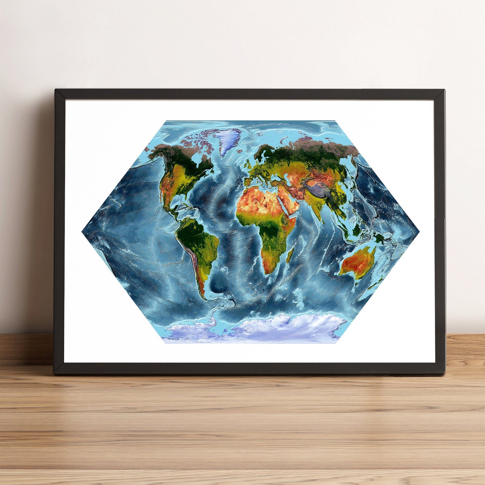 World framed shaded relief map in black frame, showing Eckert Projection. Artistic print highlighting vegetation and bathymetry