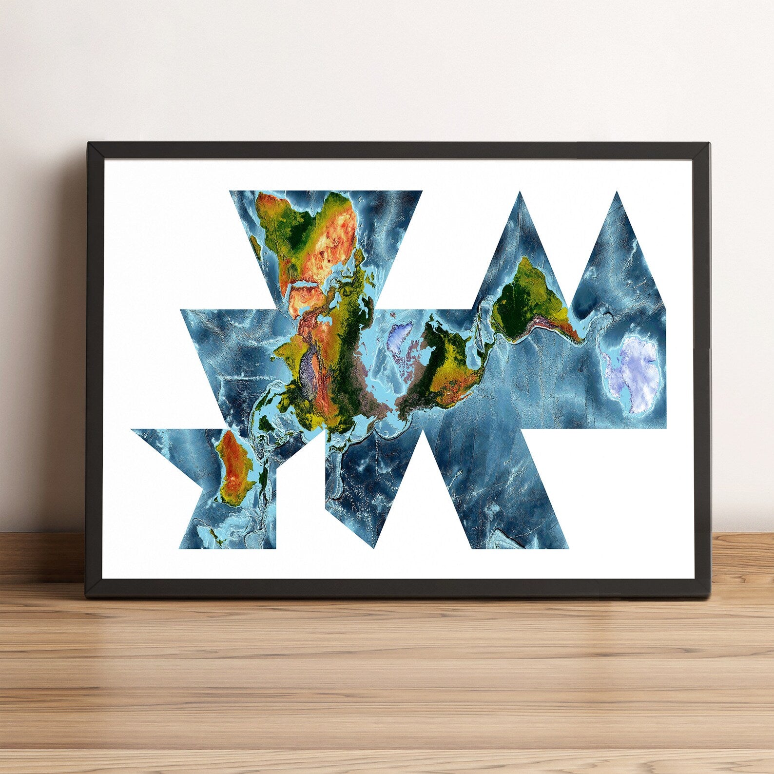 World framed shaded relief map in black frame, showing Fuller Projection. Artistic print highlighting vegetation and bathymetry