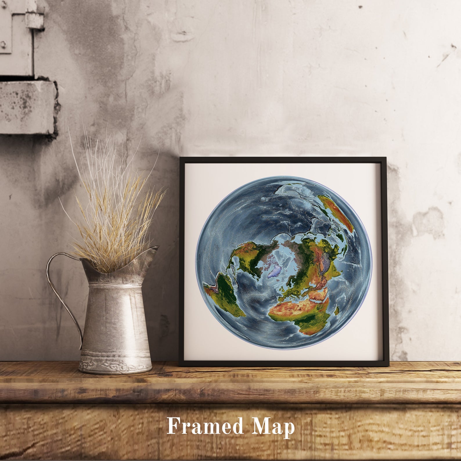 World shaded relief map in black frame, featuring the WGS 1984 Grid North Projection. Terrain art print for home decor, displayed on rustic wooden table