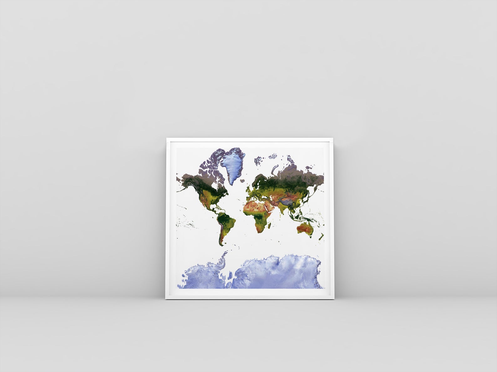 World framed shaded relief map in white frame. Mercator Projection, an artistic print highlighting mountains and vegetation