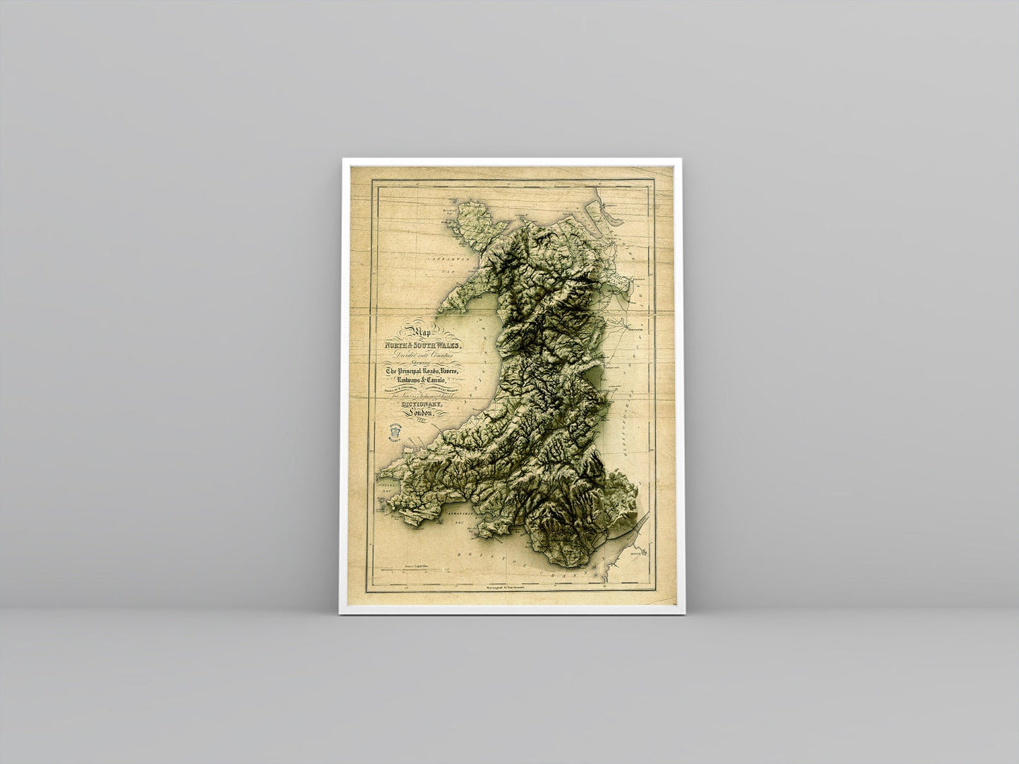 Wales vintage framed shaded relief map in white frame. Artistic print highlighting mountains with a realistic 3d effect