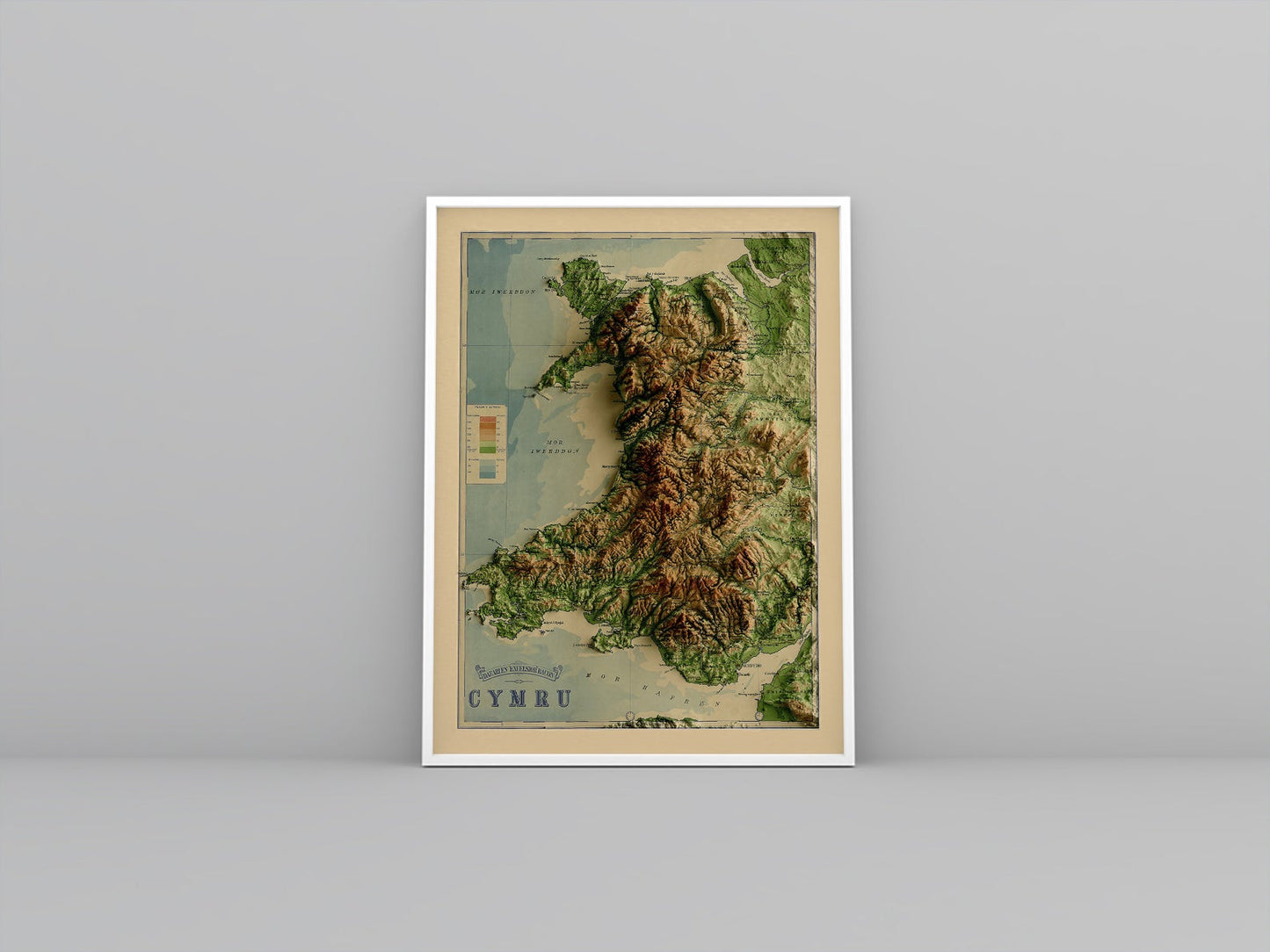 Wales vintage framed shaded relief map in white frame. Artistic print highlighting mountains with a realistic 3d effect