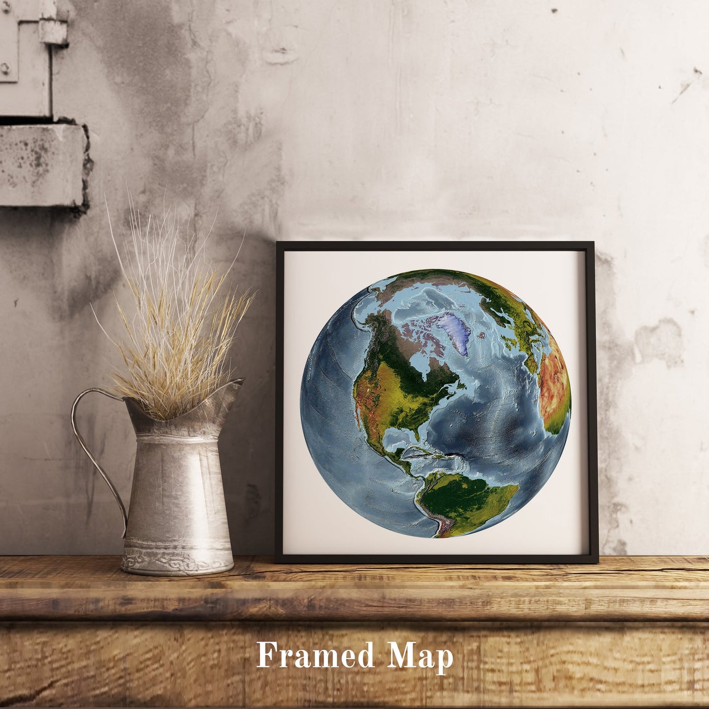 World shaded relief map in black frame, featuring the The World From Space Projection. Terrain art print for home decor, displayed on rustic wooden table