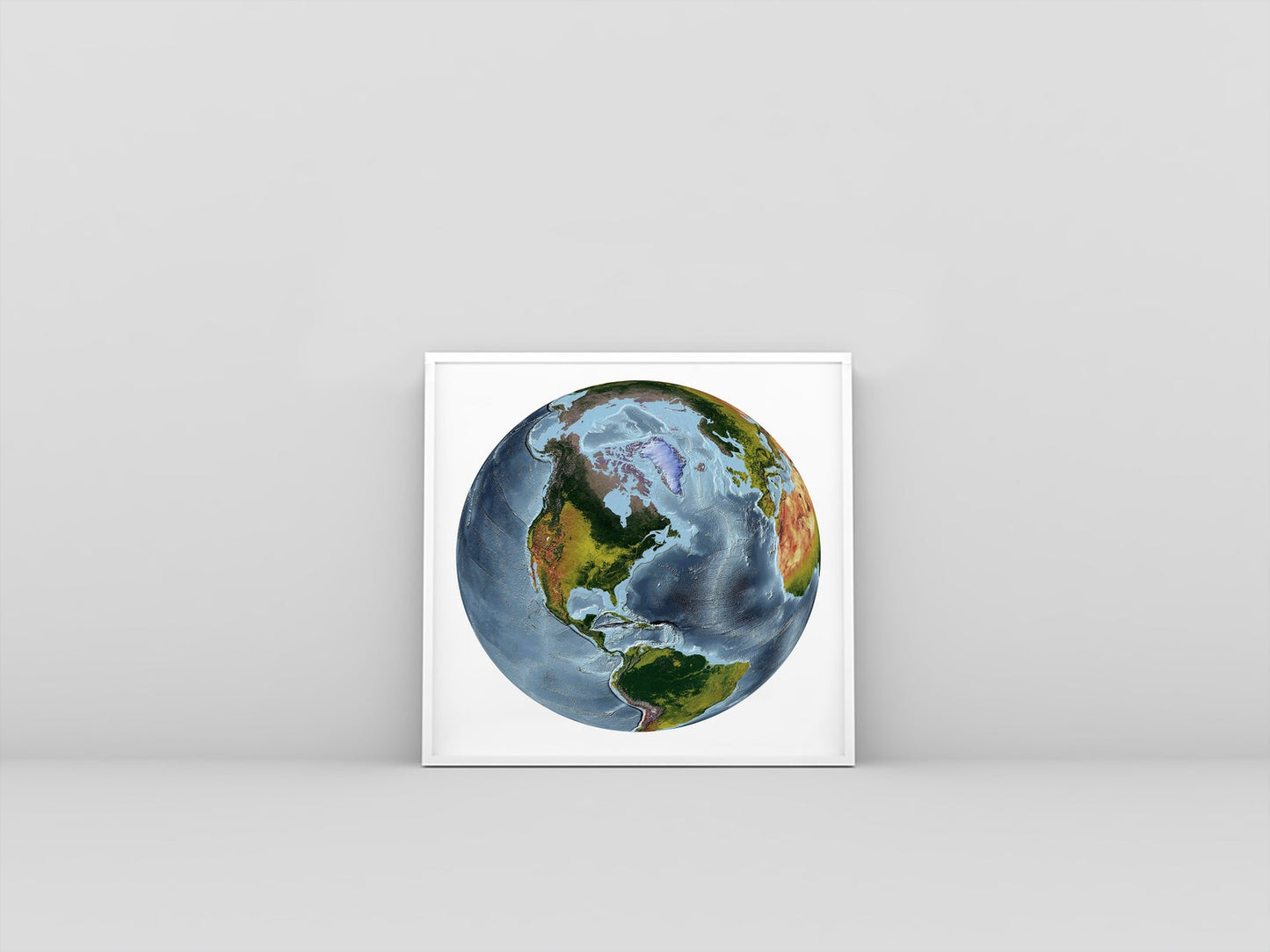 World framed shaded relief map in white frame. The World From Space Projection, an artistic print highlighting mountains and vegetation