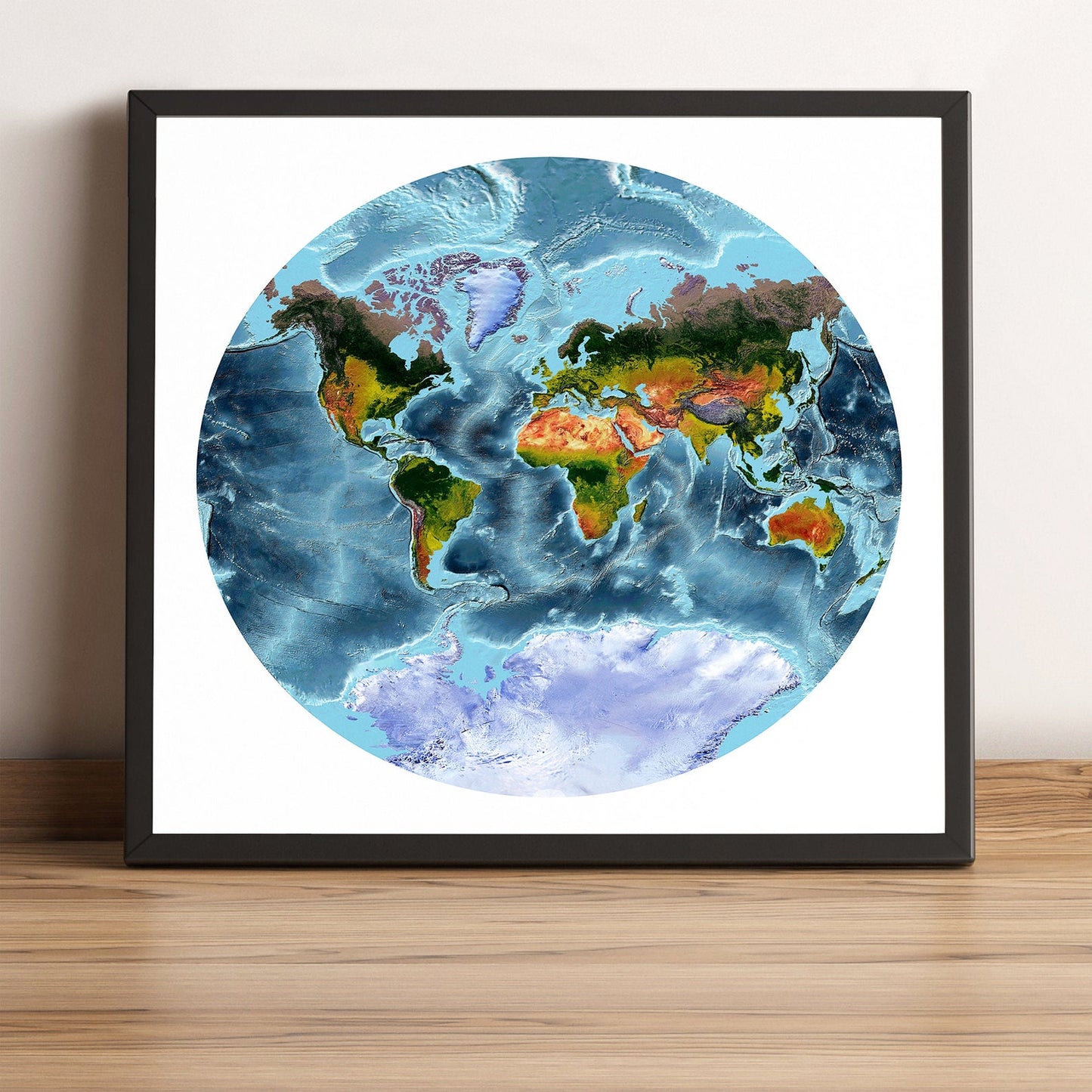 World framed shaded relief map in black frame, showing Van der Grinten Projection. Artistic print highlighting vegetation and bathymetry