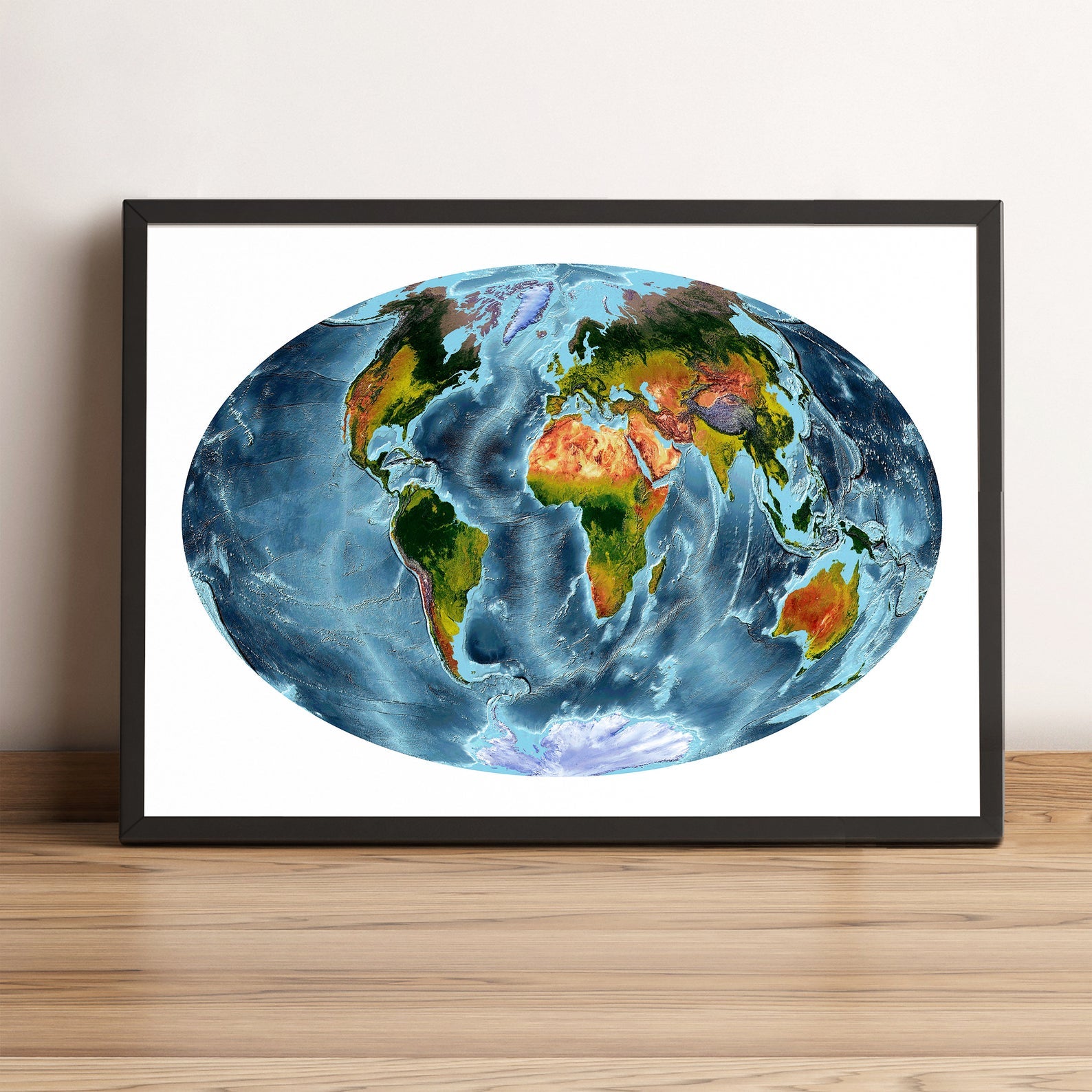 World framed shaded relief map in black frame, showing Aitoff Projection. Artistic print highlighting vegetation and bathymetry