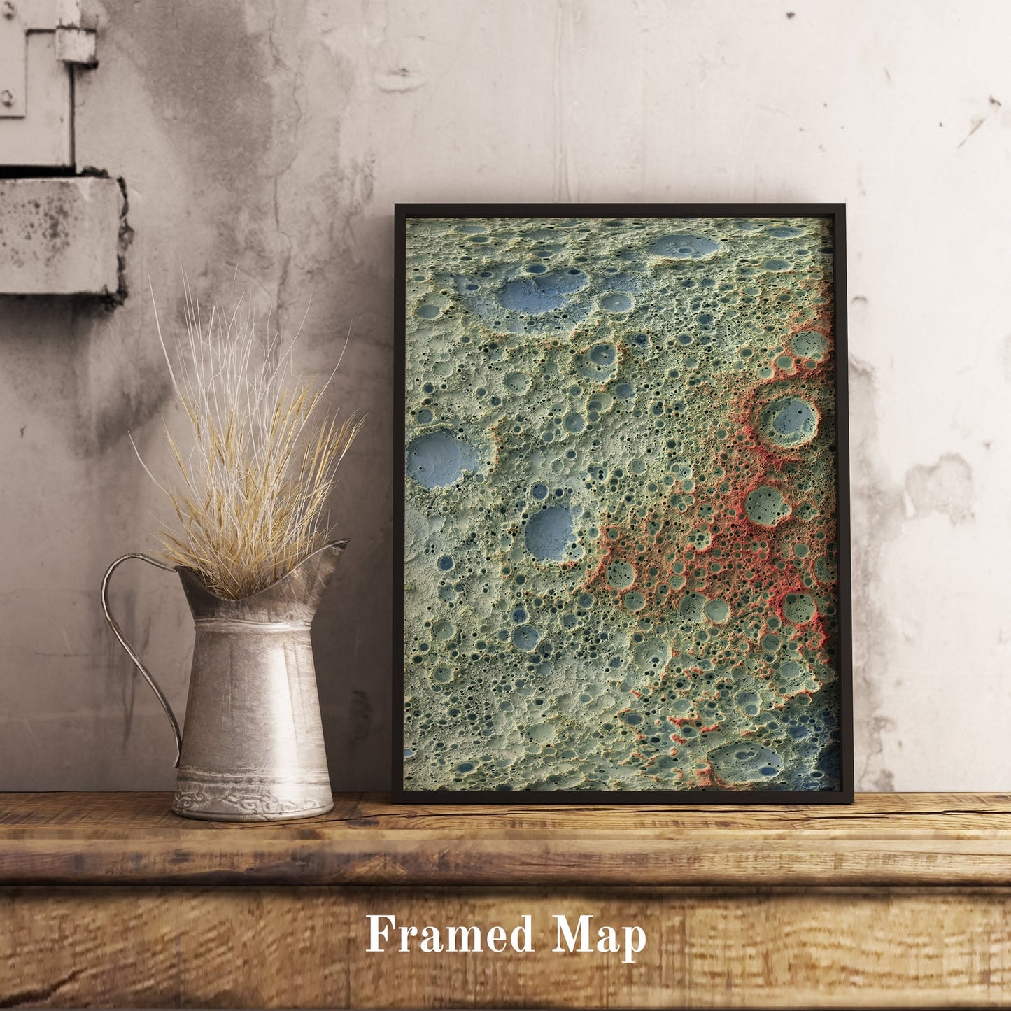 Moon shaded relief map in black frame. Realistic terrain art print for home decor, displayed on rustic wooden table