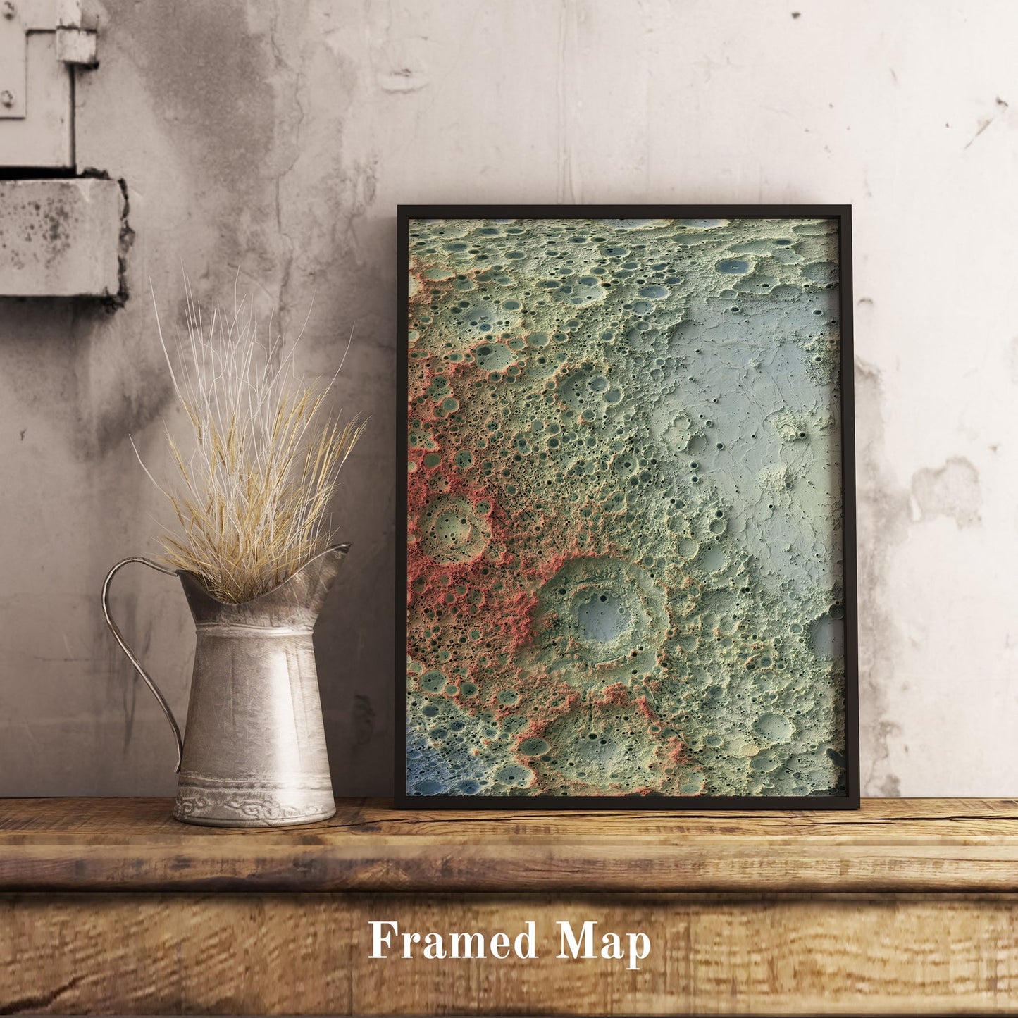 Moon shaded relief map in black frame. Realistic terrain art print for home decor, displayed on rustic wooden table