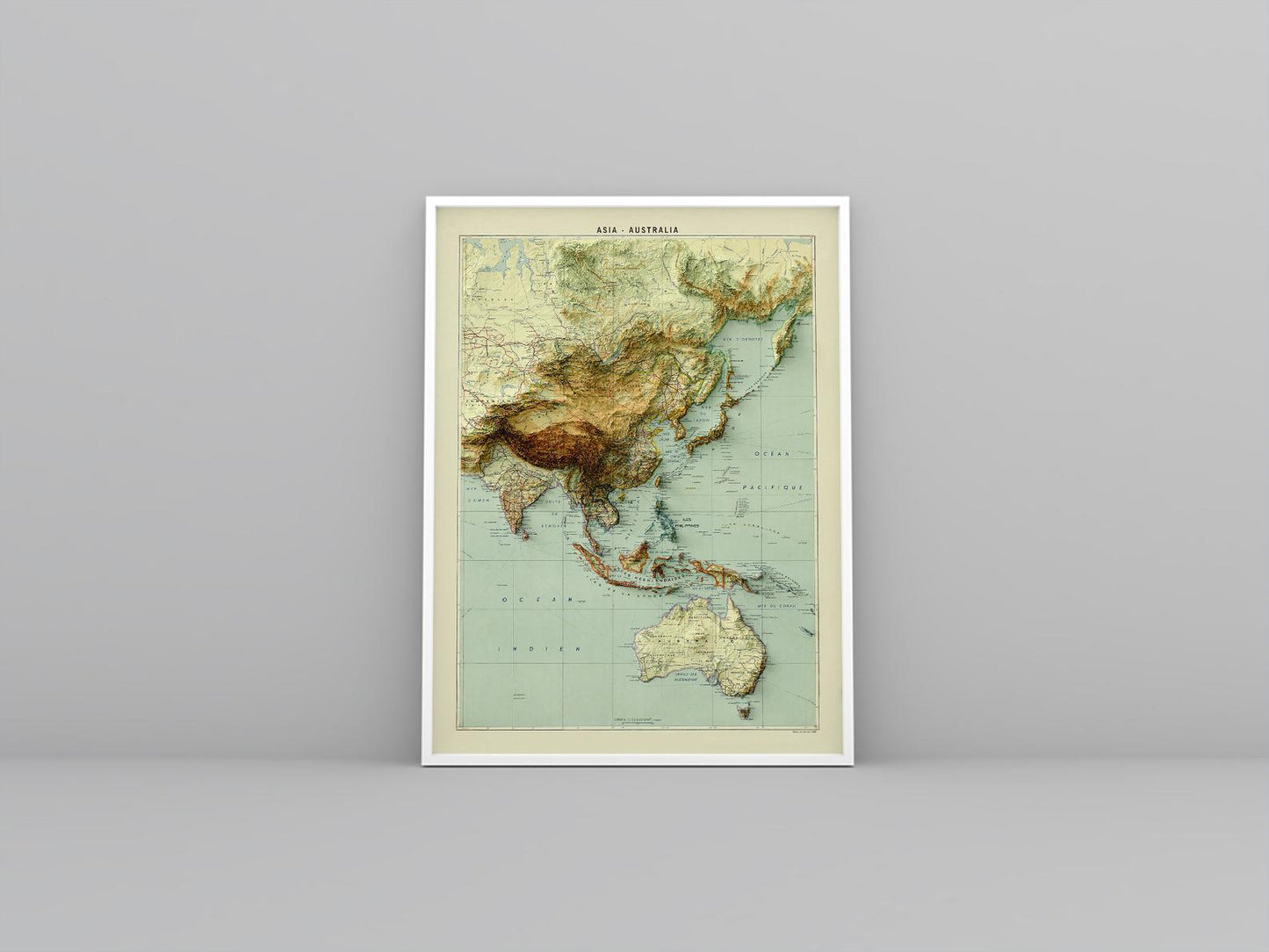 Asia and Australia vintage framed shaded relief map in white frame. Artistic print highlighting mountains with a realistic 3d effect