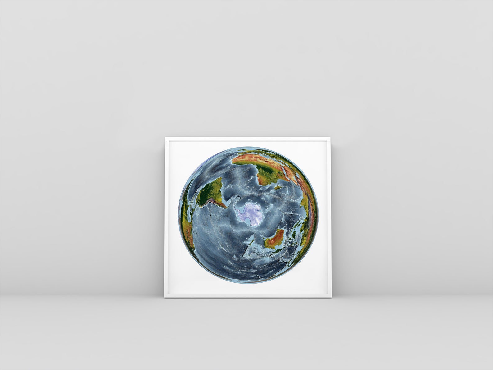 World framed shaded relief map in white frame. WGS 1984 Grid South Projection, an artistic print highlighting mountains and vegetation