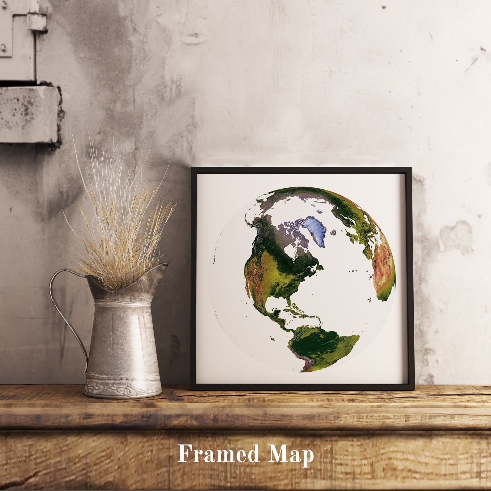 World shaded relief map in black frame, featuring the The World From Space Projection. Terrain art print for home decor, displayed on rustic wooden table