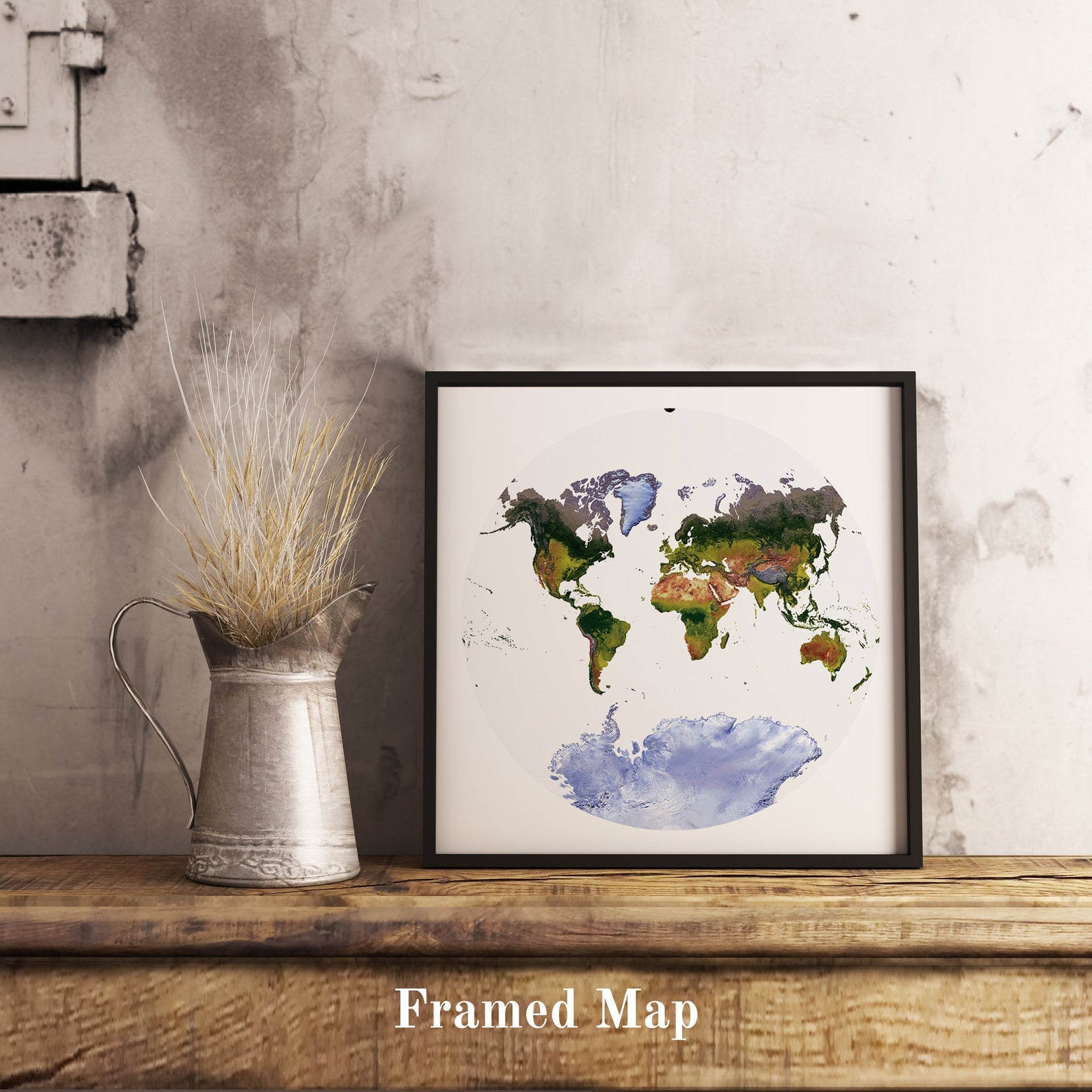 World shaded relief map in black frame, featuring the Van der Grinten Projection. Terrain art print for home decor, displayed on rustic wooden table