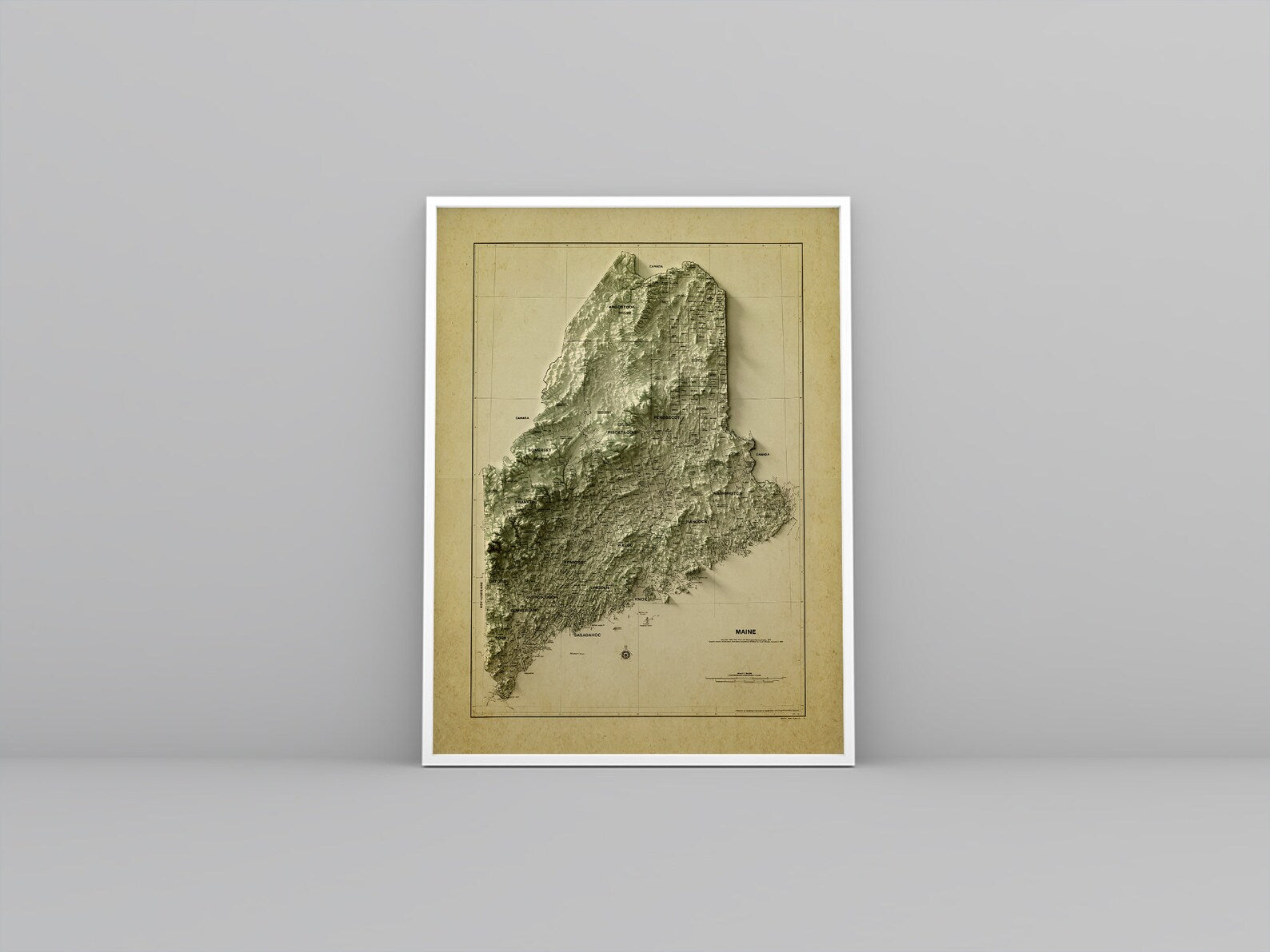 Maine (USA) vintage framed shaded relief map in white frame. Artistic print highlighting mountains with a realistic 3d effect