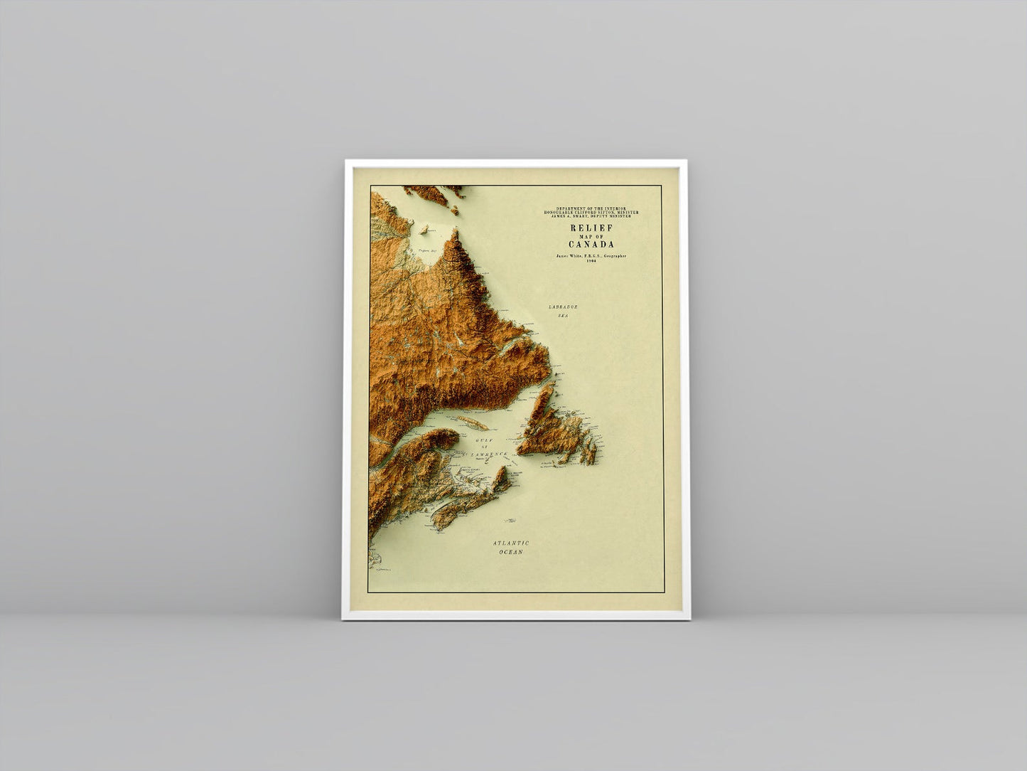 Atlantic Canada vintage framed shaded relief map in white frame. Artistic print highlighting mountains with a realistic 3d effect