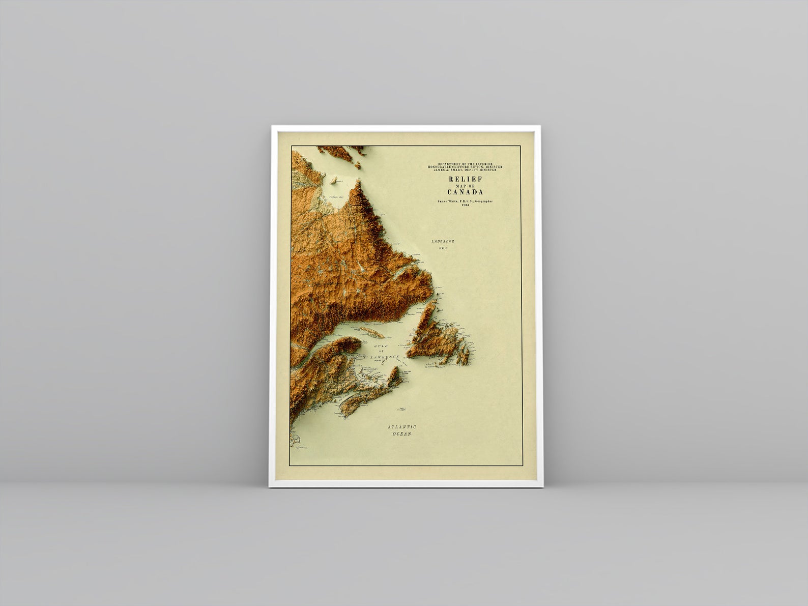 Atlantic Canada vintage framed shaded relief map in white frame. Artistic print highlighting mountains with a realistic 3d effect