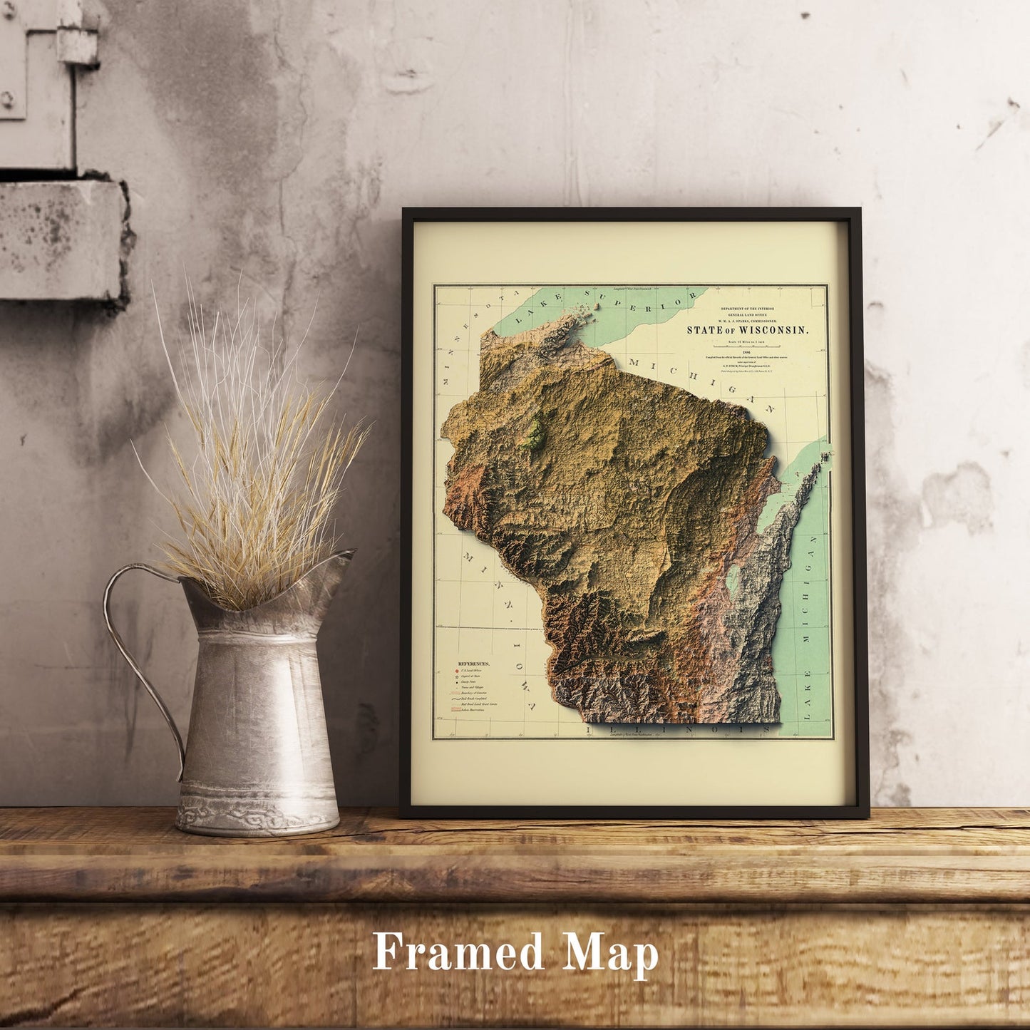 Vintage Wisconsin (USA) shaded relief map in black frame. Realistic terrain art print for home decor, displayed on rustic wooden table
