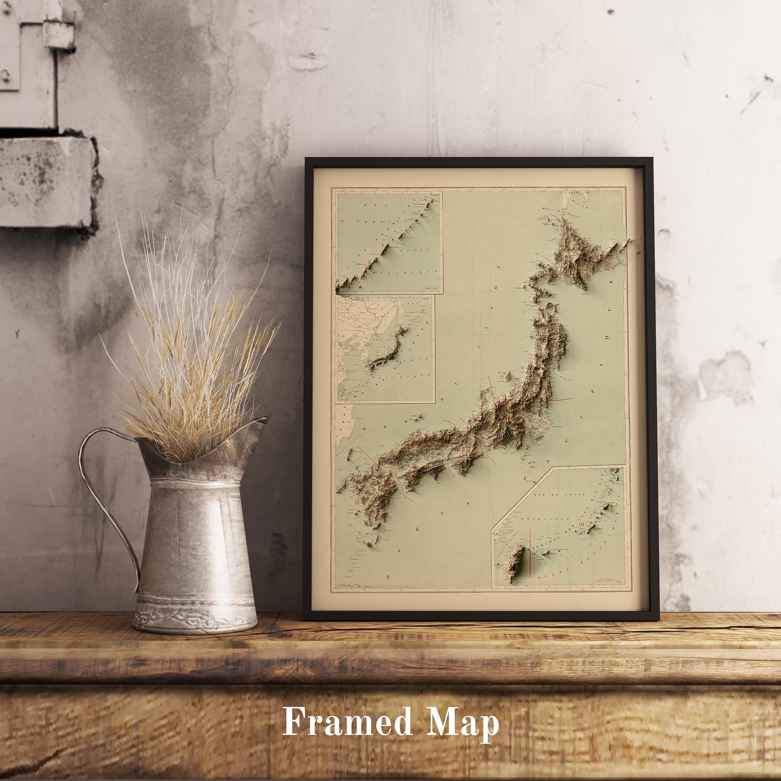 Vintage Japan shaded relief map in black frame. Realistic terrain art print for home decor, displayed on rustic wooden table