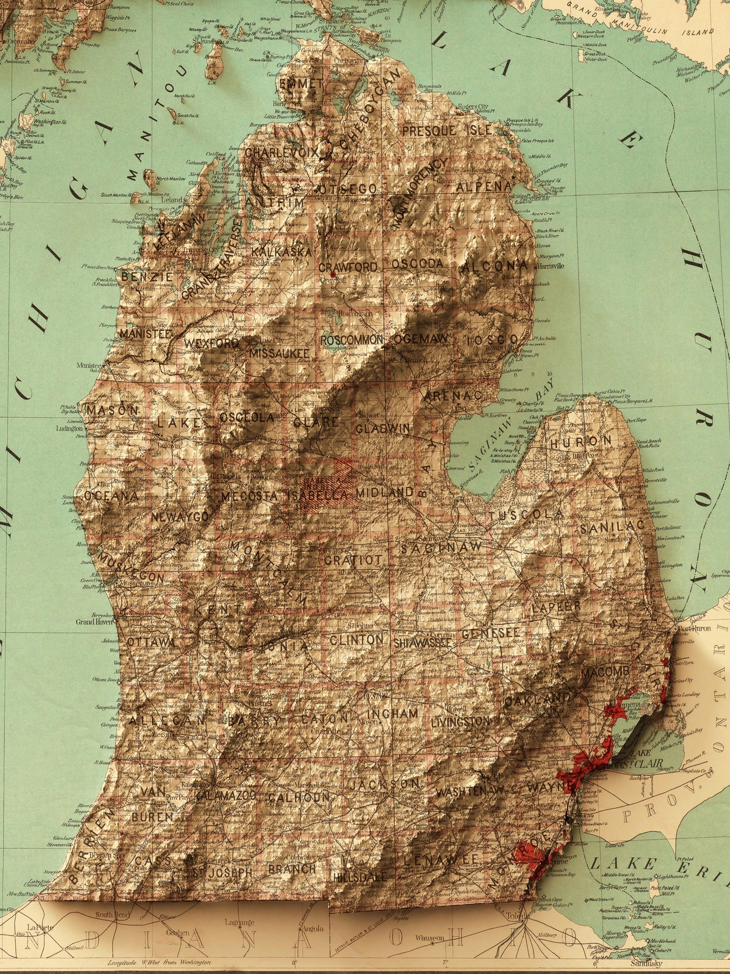 Detailed close-up of a vintage Michigan (USA) relief map, showcasing textured topography and geographic contours