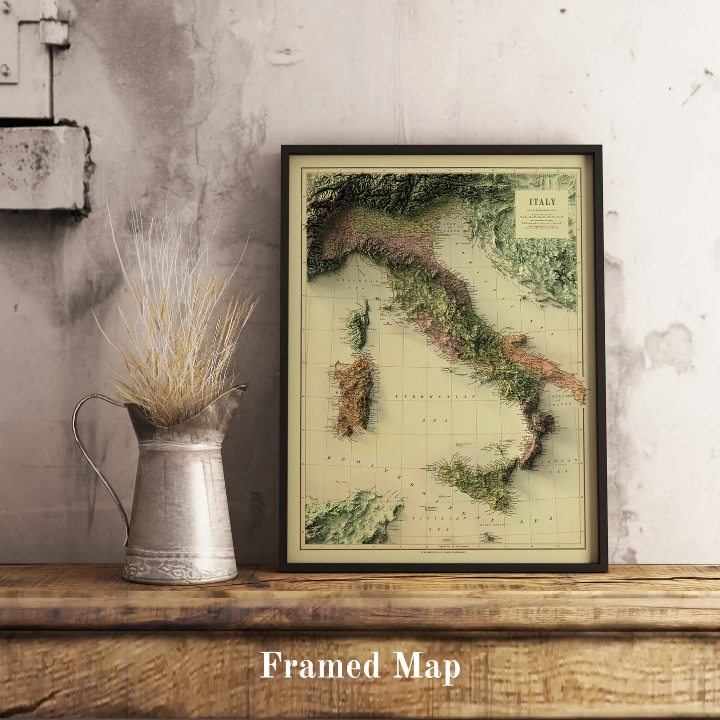 Vintage Italy shaded relief map in black frame. Realistic terrain art print for home decor, displayed on rustic wooden table
