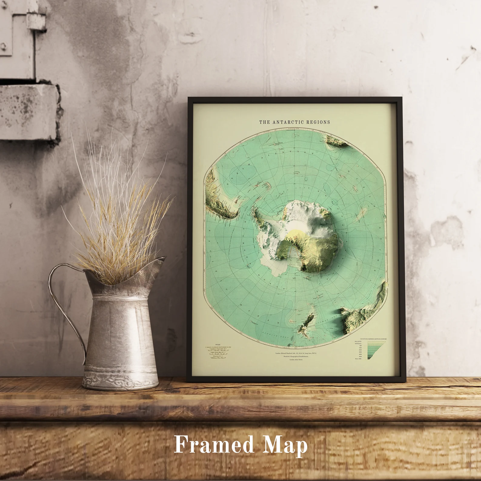 Vintage Antartctic shaded relief map in black frame. Realistic terrain art print for home decor, displayed on rustic wooden table