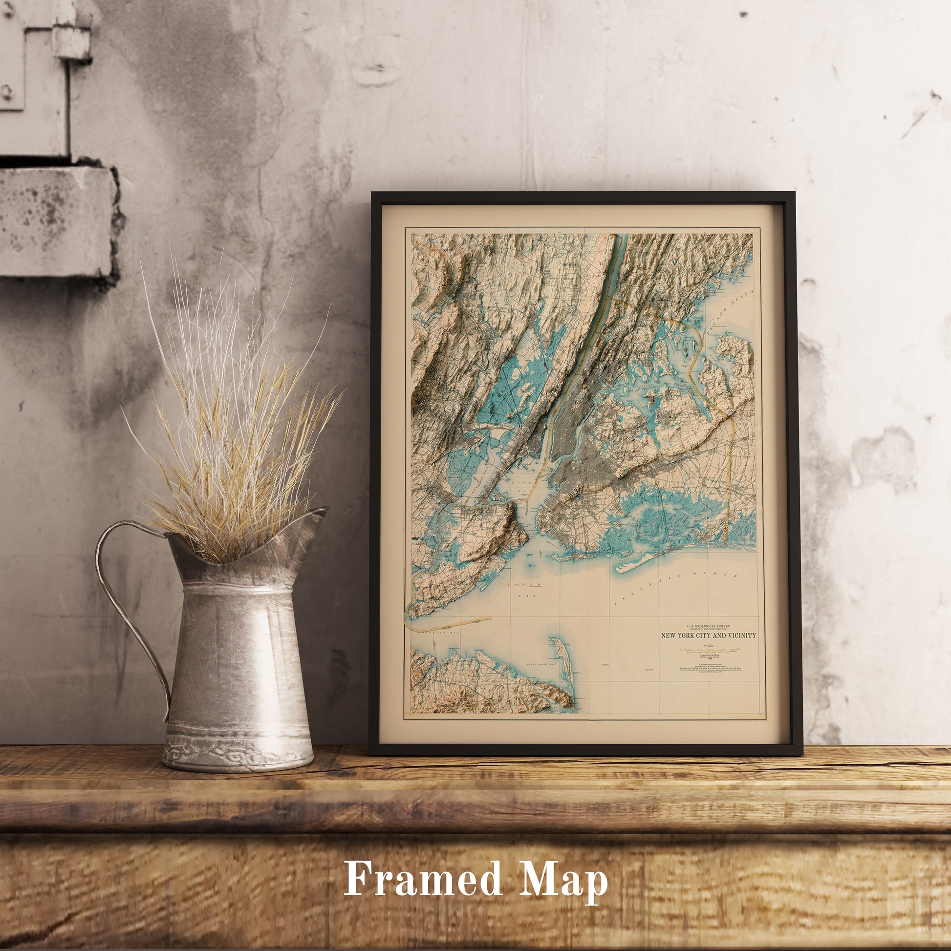Vintage New York City shaded relief map in black frame. Realistic terrain art print for home decor, displayed on rustic wooden table