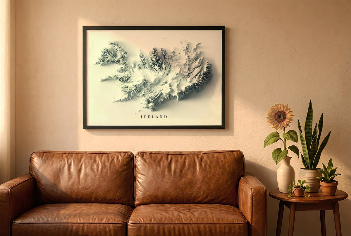 Iceland relief map in a black frame above a brown leather sofa. Boho living room with warm sunlight, sunflower, and indoor plants on a wooden side table
