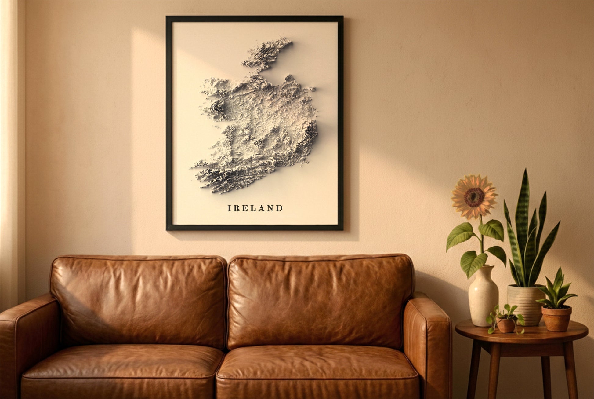 Ireland relief map in a black frame above a brown leather sofa. Boho living room with warm sunlight, sunflower, and indoor plants on a wooden side table
