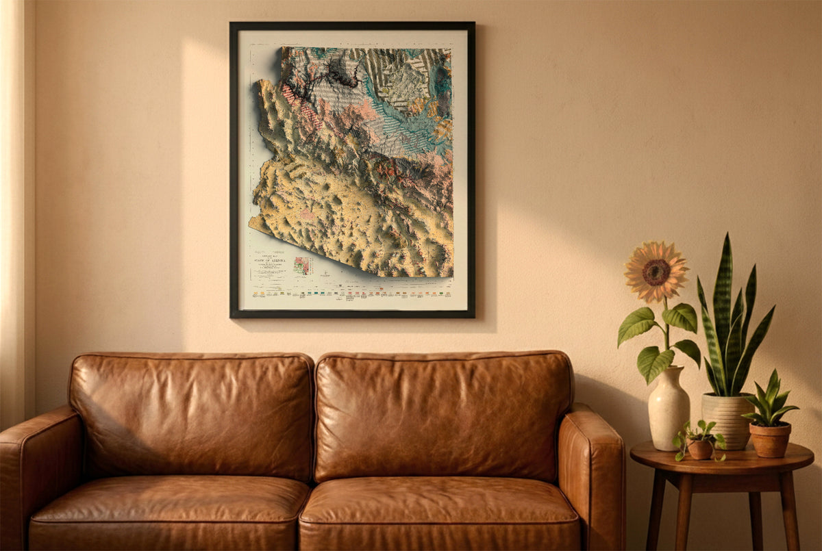 Arizona vintage geological relief map in a black frame above a brown leather sofa. Boho living room with warm sunlight, sunflower, and indoor plants on a wooden side table