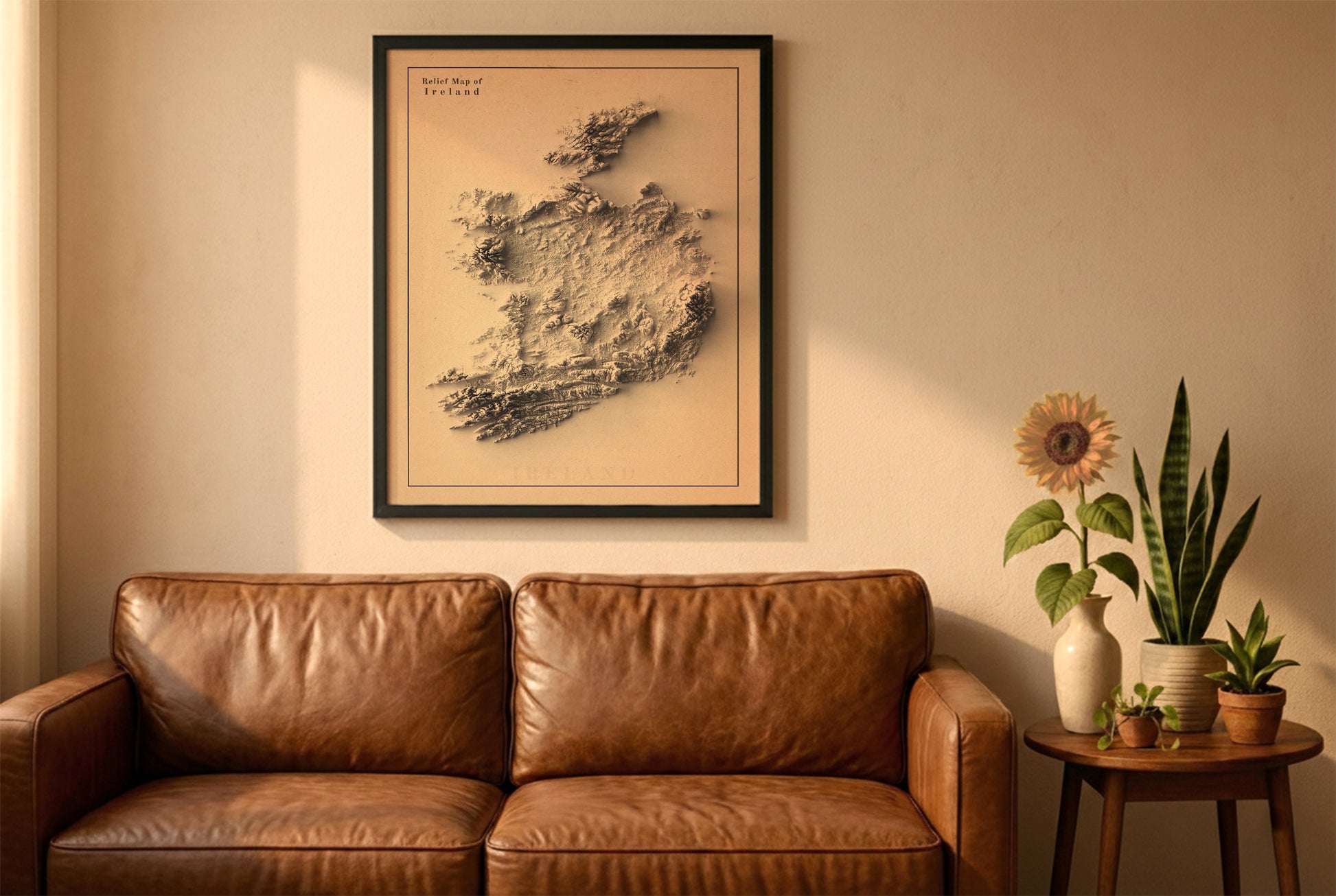 Ireland relief map in a black frame above a brown leather sofa. Boho living room with warm sunlight, sunflower, and indoor plants on a wooden side table