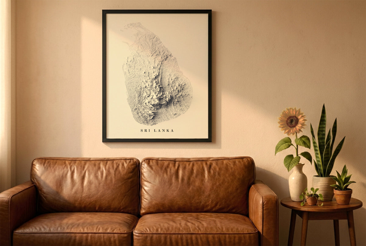Sri Lanka relief map in a black frame above a brown leather sofa. Boho living room with warm sunlight, sunflower, and indoor plants on a wooden side table