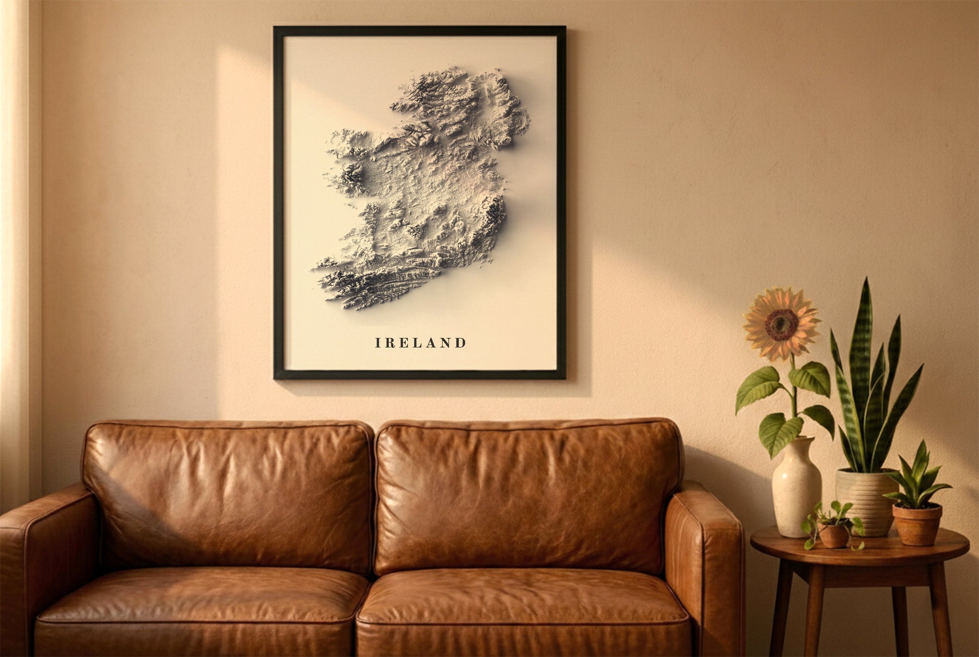 Ireland relief map in a black frame above a brown leather sofa. Boho living room with warm sunlight, sunflower, and indoor plants on a wooden side table