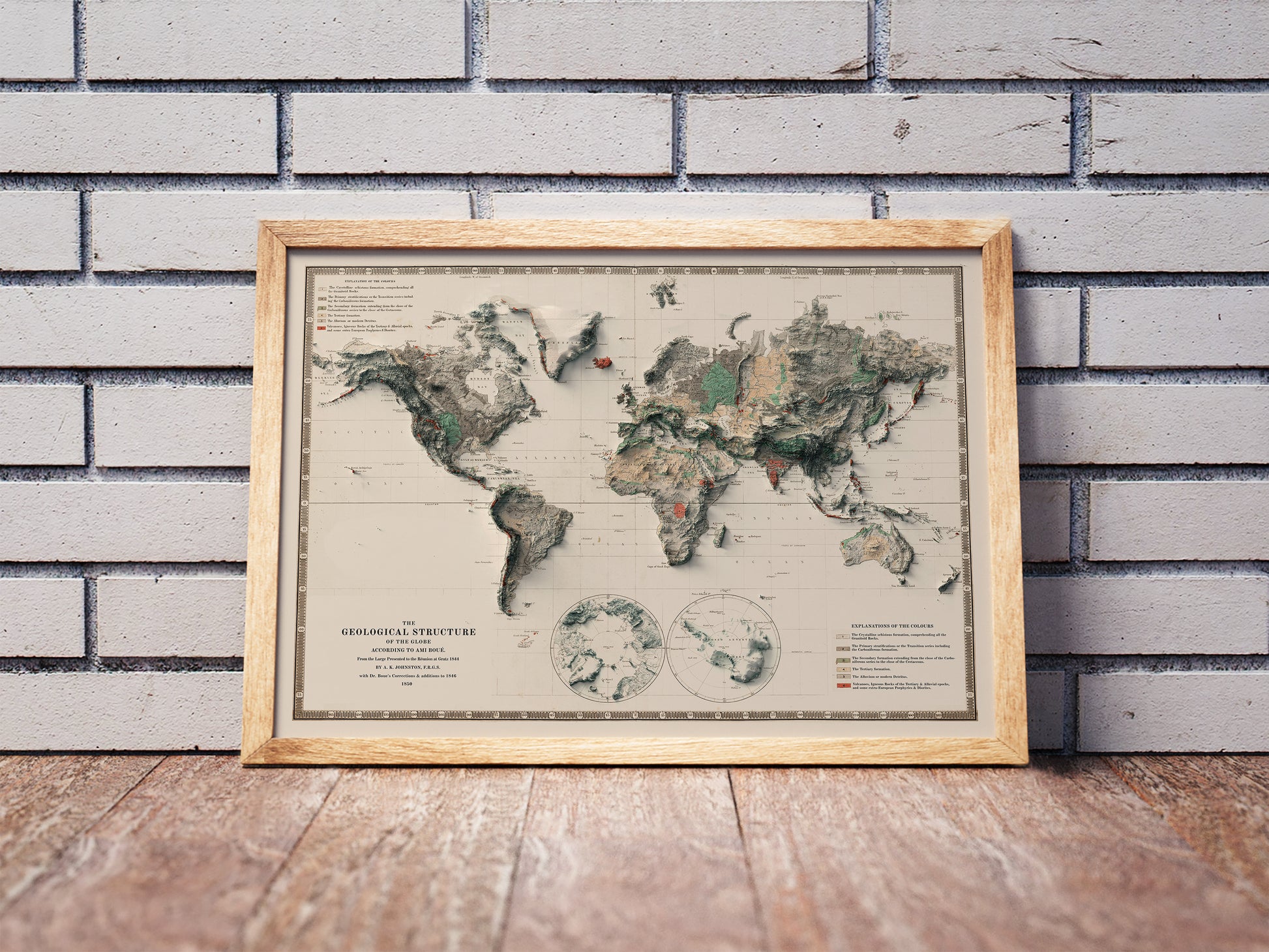 Vintage World shaded relief map in a wooden frame. Realistic terrain art print for home decor, displayed against a brick wall