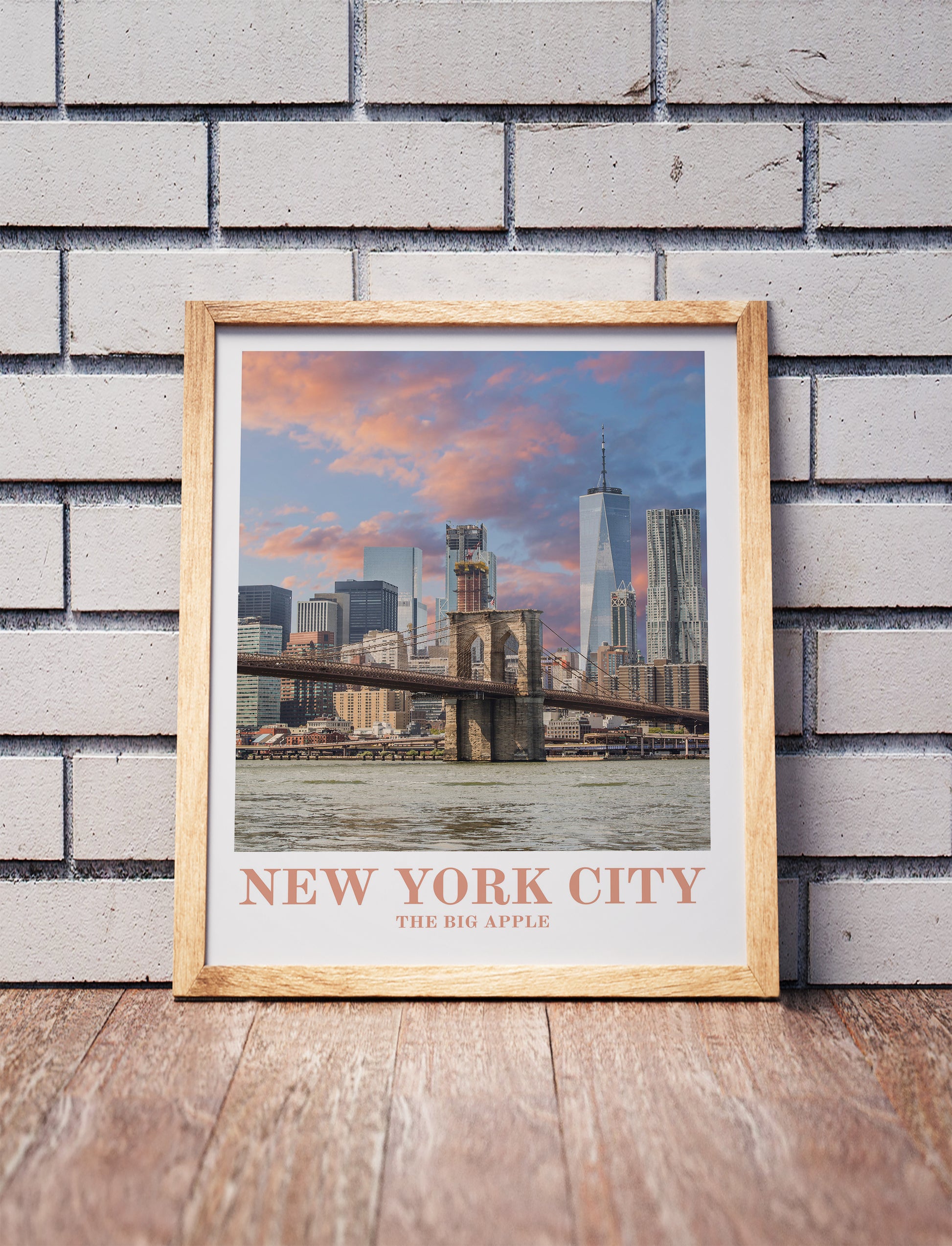 New York City poster in a wooden frame. Realistic terrain art print for home decor, displayed against a brick wall