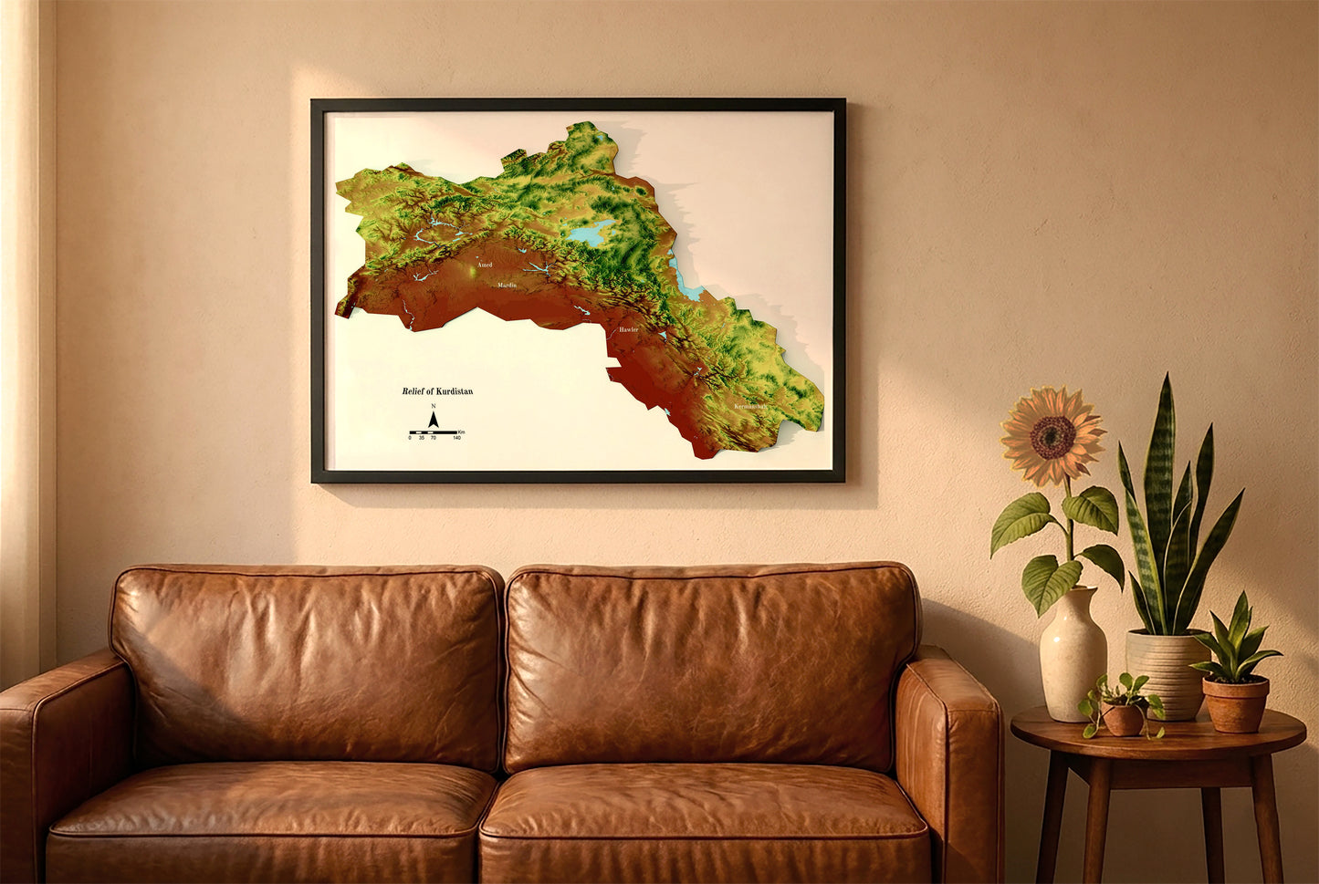 Kurdistan vintage relief map in a black frame above a brown leather sofa. Boho living room with warm sunlight, sunflower, and indoor plants on a wooden side table