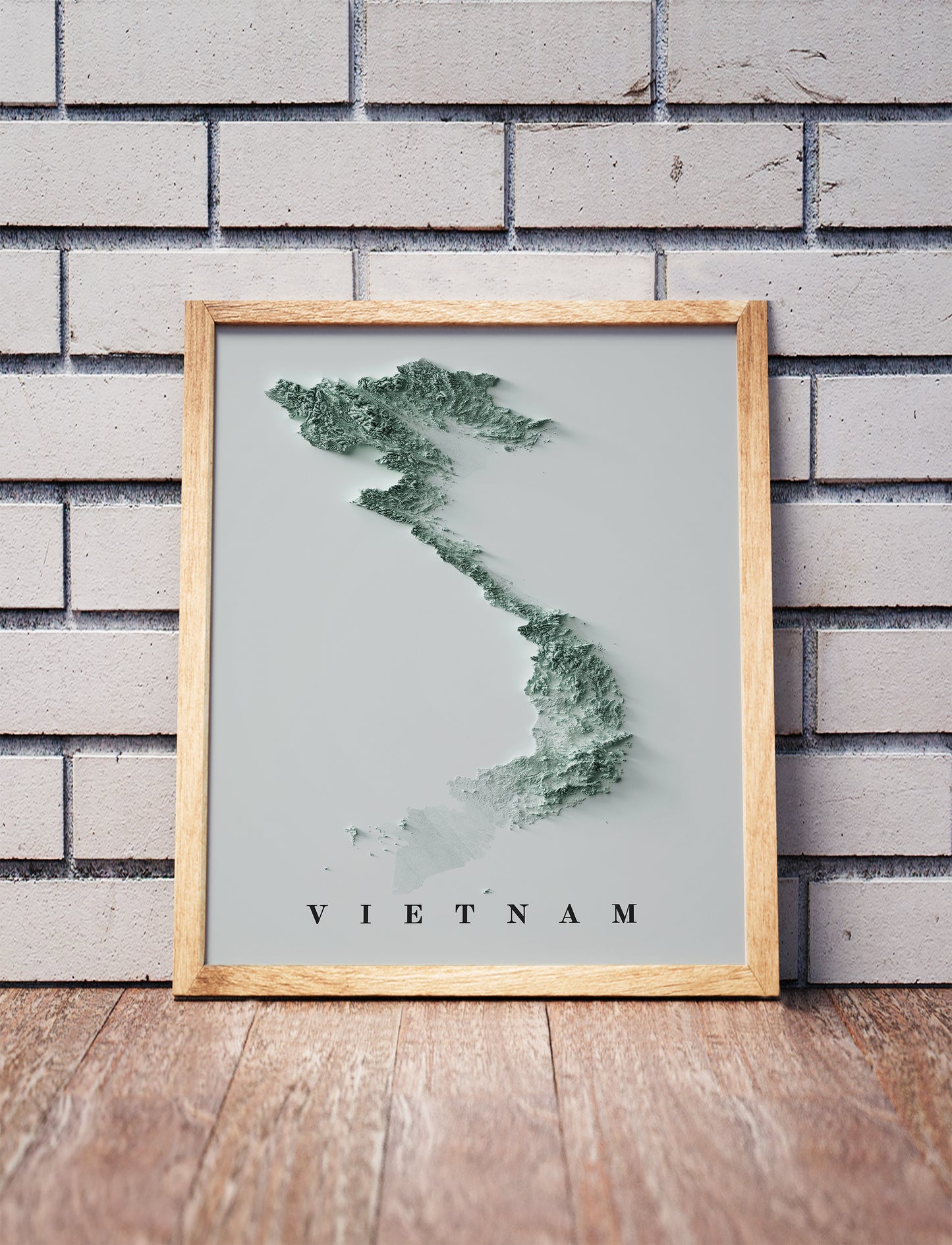 Vietnam relief map in a black frame above a brown leather sofa. Boho living room with warm sunlight, sunflower, and indoor plants on a wooden side table