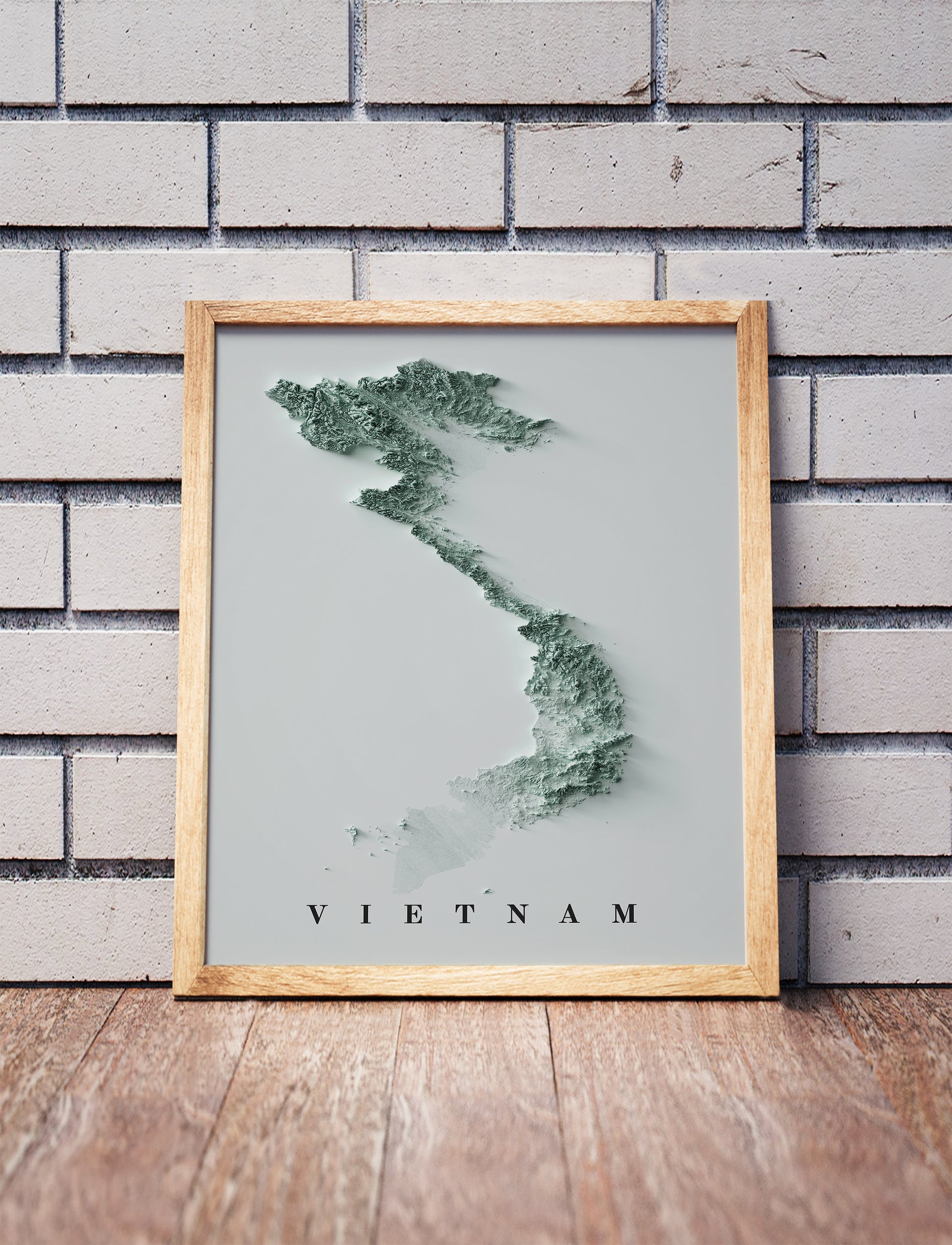 Vietnam relief map in a black frame above a brown leather sofa. Boho living room with warm sunlight, sunflower, and indoor plants on a wooden side table