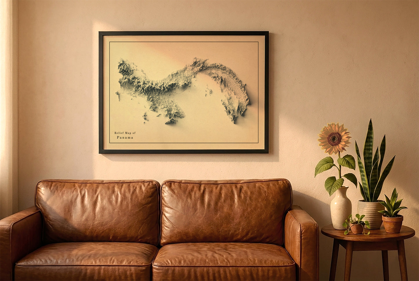 Panama vintage relief map in a black frame above a brown leather sofa. Boho living room with warm sunlight, sunflower, and indoor plants on a wooden side table