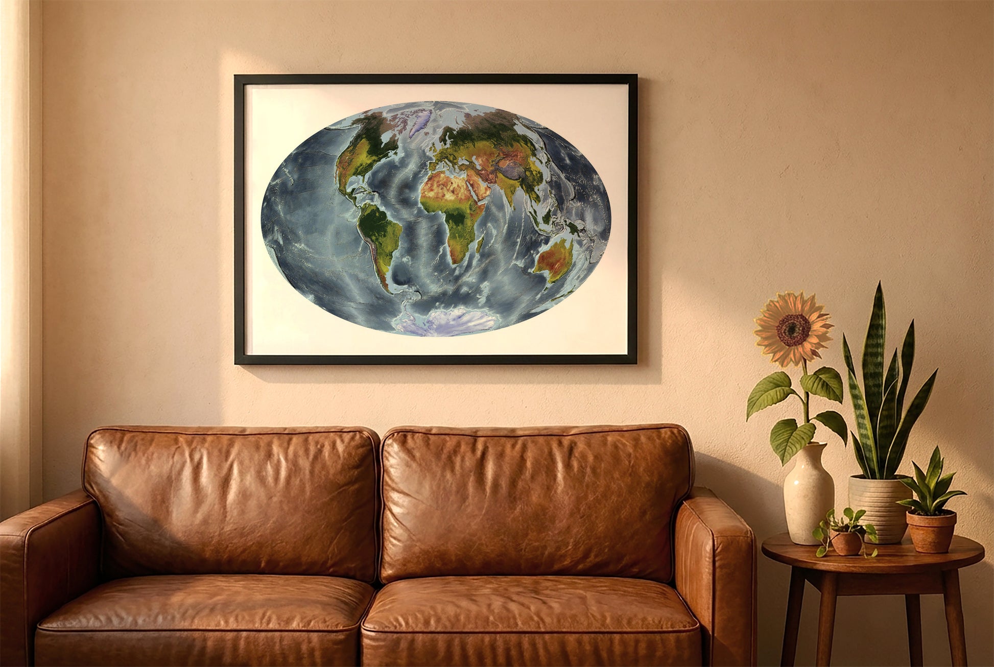World relief map in aitoff projection in a black frame above a brown leather sofa. Boho living room with warm sunlight, sunflower, and indoor plants on a wooden side table