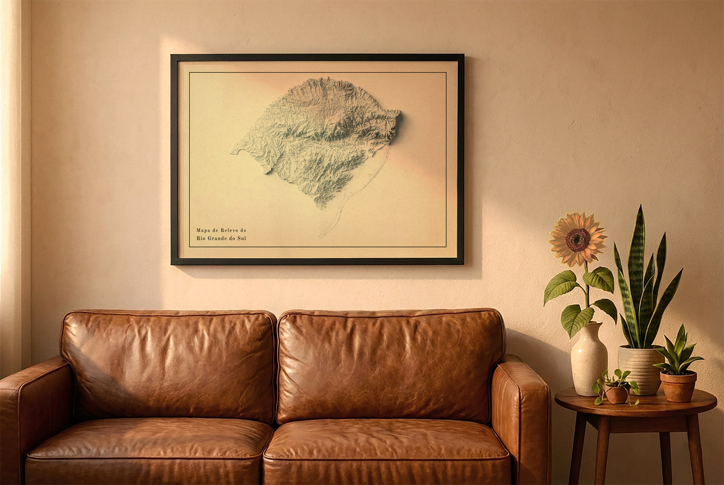 Rio Grande do Sul, Brazil, vintage relief map in a black frame above a brown leather sofa. Boho living room with warm sunlight, sunflower, and indoor plants on a wooden side table