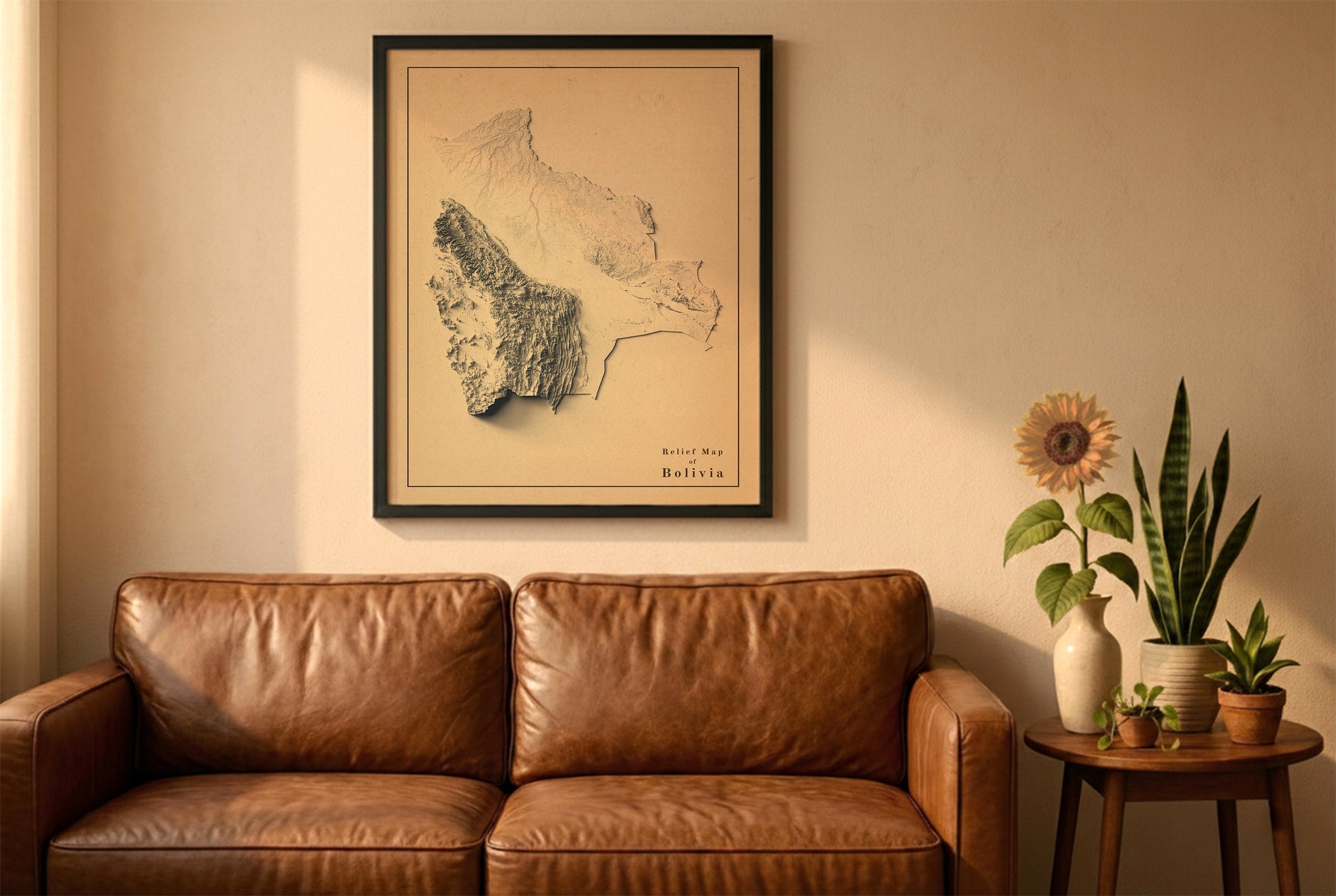 Bolivia vintage relief map in a black frame above a brown leather sofa. Boho living room with warm sunlight, sunflower, and indoor plants on a wooden side table