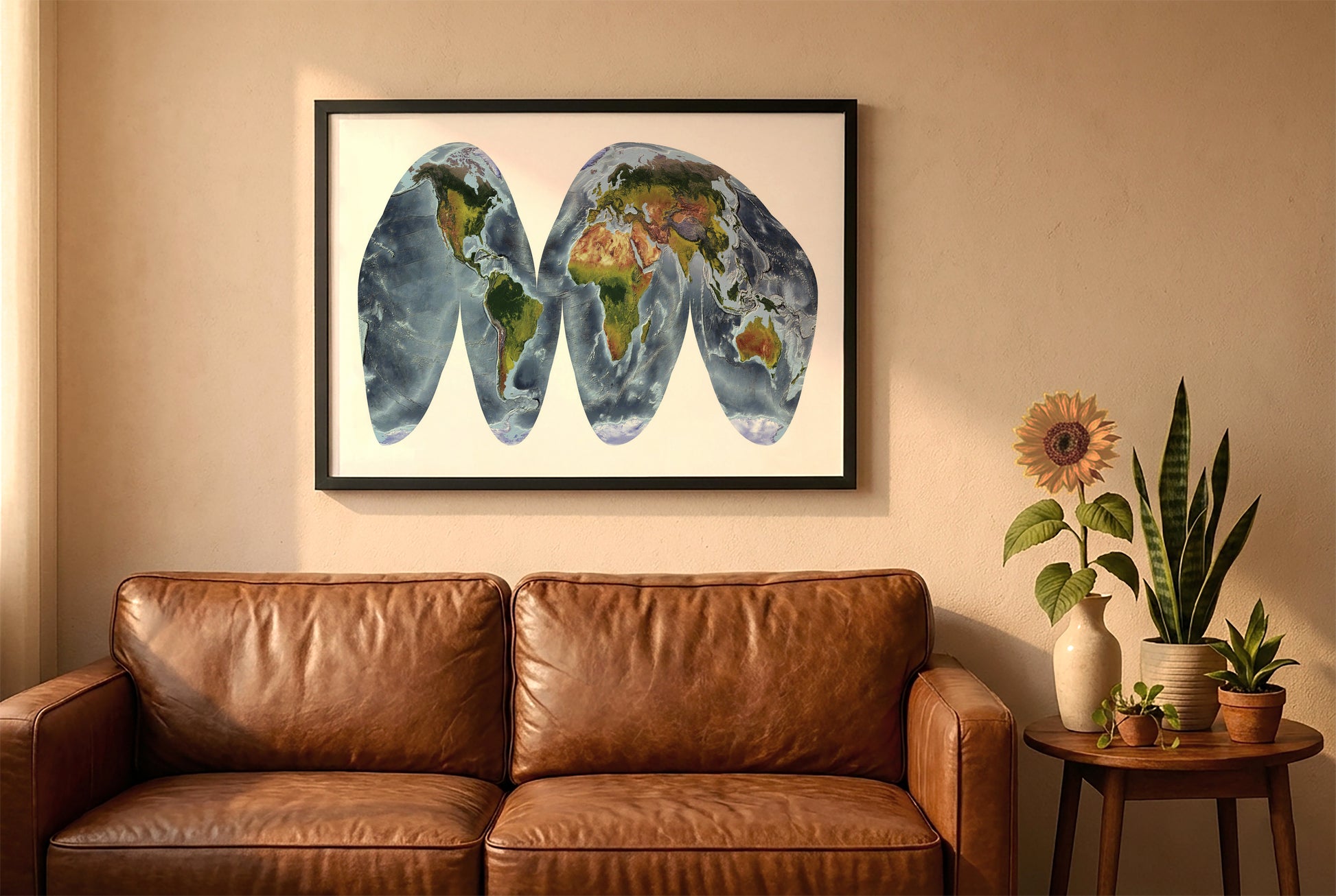World relief map in goode homolosine land projection in a black frame above a brown leather sofa. Boho living room with warm sunlight, sunflower, and indoor plants on a wooden side table