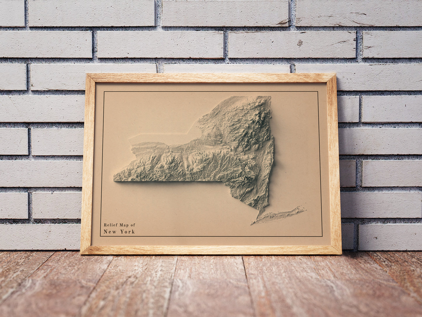 Vintage New York state shaded relief map in a wooden frame. Realistic terrain art print for home decor, displayed against a brick wall
