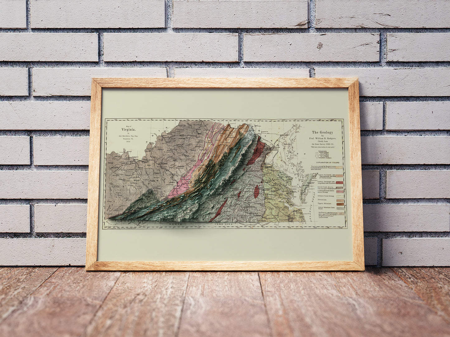 Vintage Virginia shaded relief map in a wooden frame. Realistic terrain art print for home decor, displayed against a brick wall